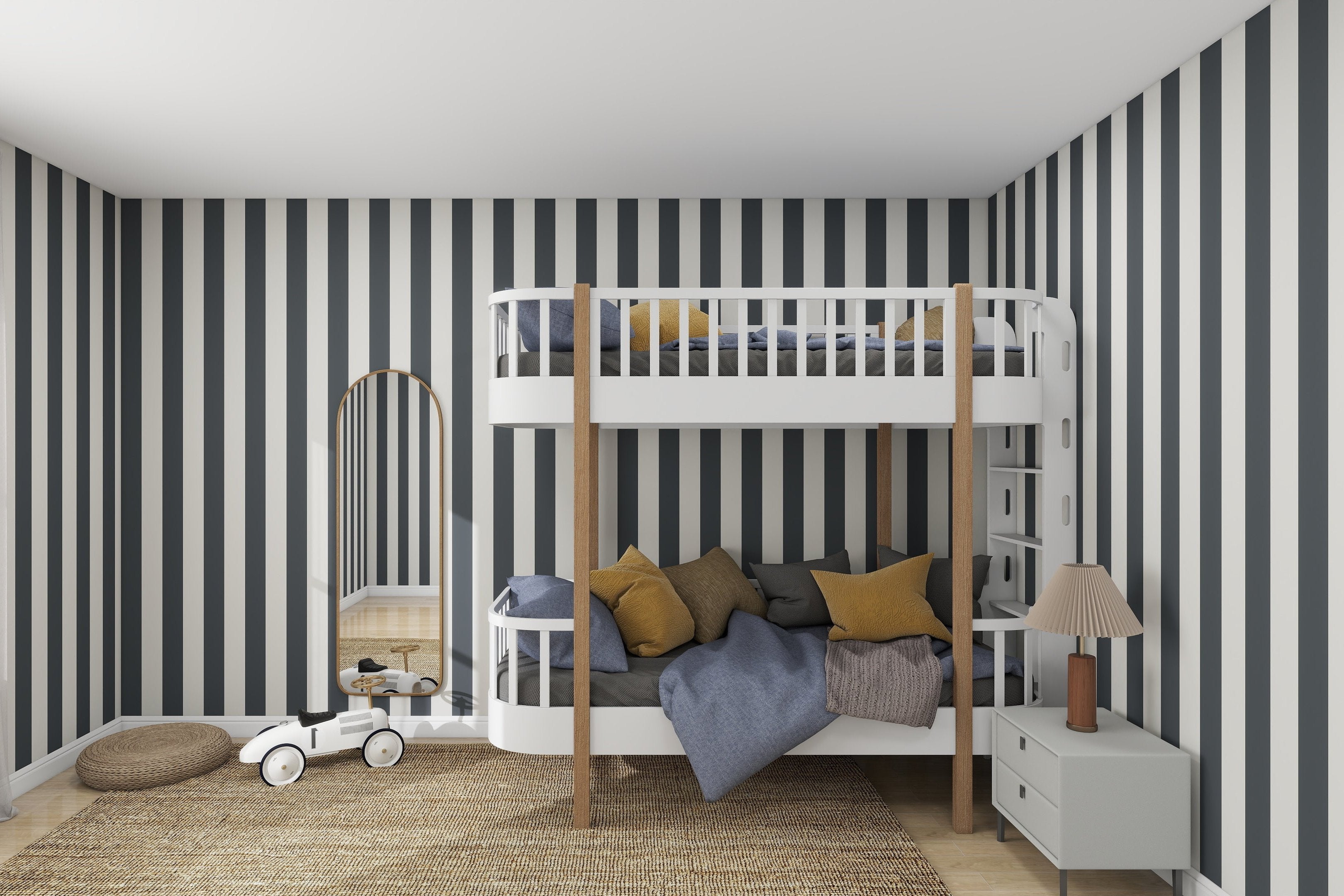 The contemporary bedroom has a lively feel with Circus Stripe Wallpaper Denim by munks and me. It includes a white bunk bed with wood accents, gray and mustard pillows, a woven rug, and charm is added by a small white dresser with a lamp and toy car.