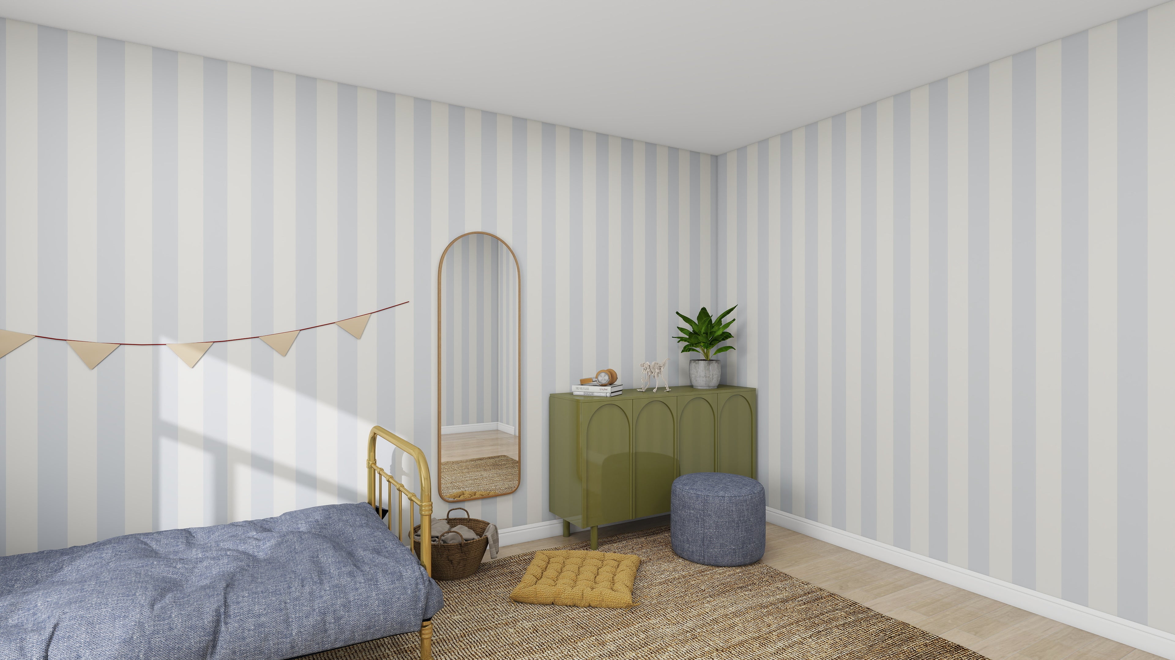 A cozy bedroom features Munks and Mes Circus Stripe Wallpaper Sky, a yellow metal bed with blue bedding, a round pouf, and a green cabinet adorned with a potted plant. A tall mirror leans against the wall near a banner, and the floor is covered by a woven rug.