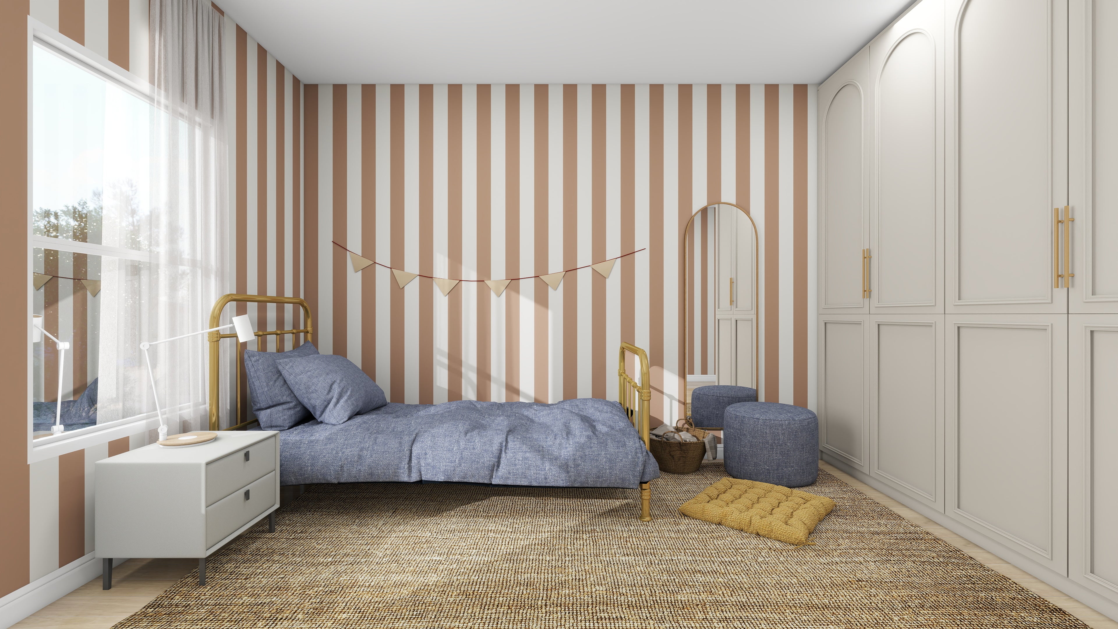 The bedroom features a cozy vibe with Circus Stripe Wallpaper Latte in beige and white by Munks and Me, a single bed with blue bedding, a white bedside table holding a lamp, basket, and poufs. Sheer-curtained windows let in natural light while a banner decorates the wall above the bed.