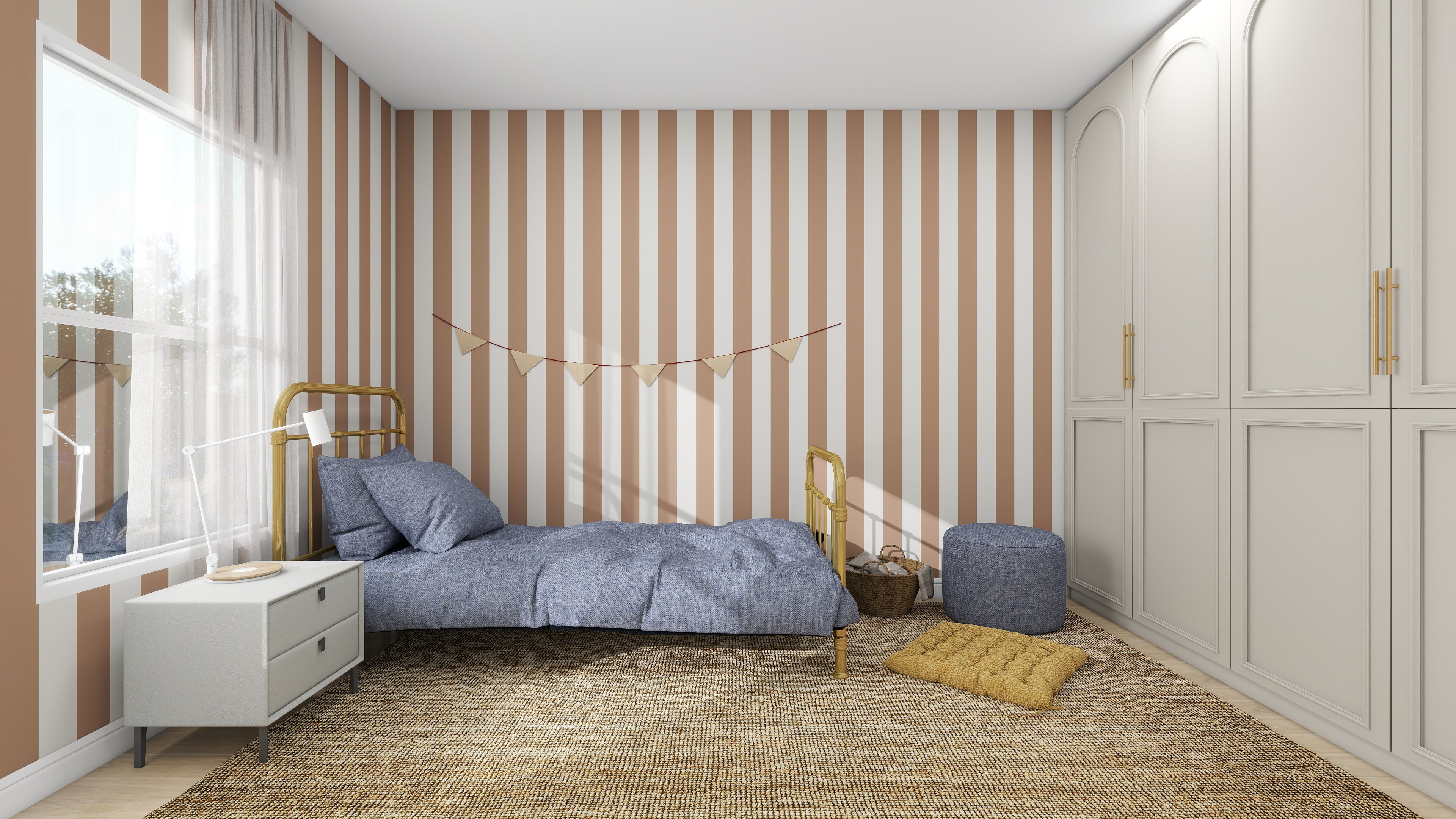 A cozy bedroom features a single bed with a blue duvet, a cushioned ottoman, and a wicker basket on a textured rug. The accent wall is enhanced by the Circus Stripe Wallpaper Latte from munks and me in brown and white. Natural light pours through the window, brightening the room.