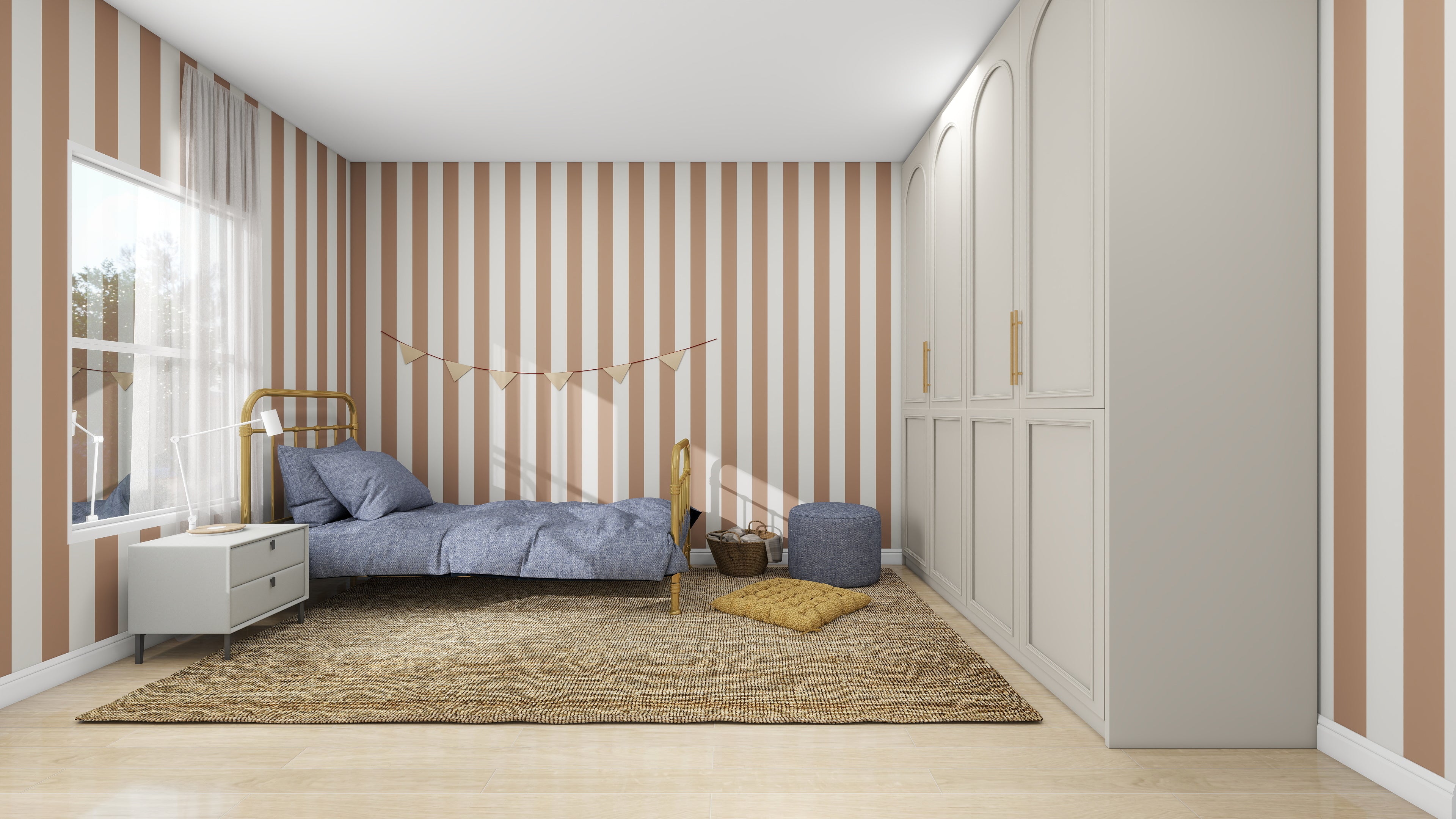 A cozy bedroom features munks and me’s Circus Stripe Wallpaper Latte, a small bed with blue bedding, a bedside table, basket, pouf, cushioned floor mat, and a large wardrobe on the right.