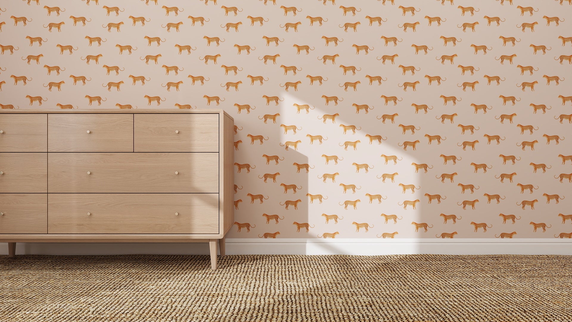 A light wood dresser sits on a woven rug against a wall decorated with quirky Goldies Cheetah Repeat Pattern Pink wallpaper. Sunlight casts a window-shaped shadow on the wall.