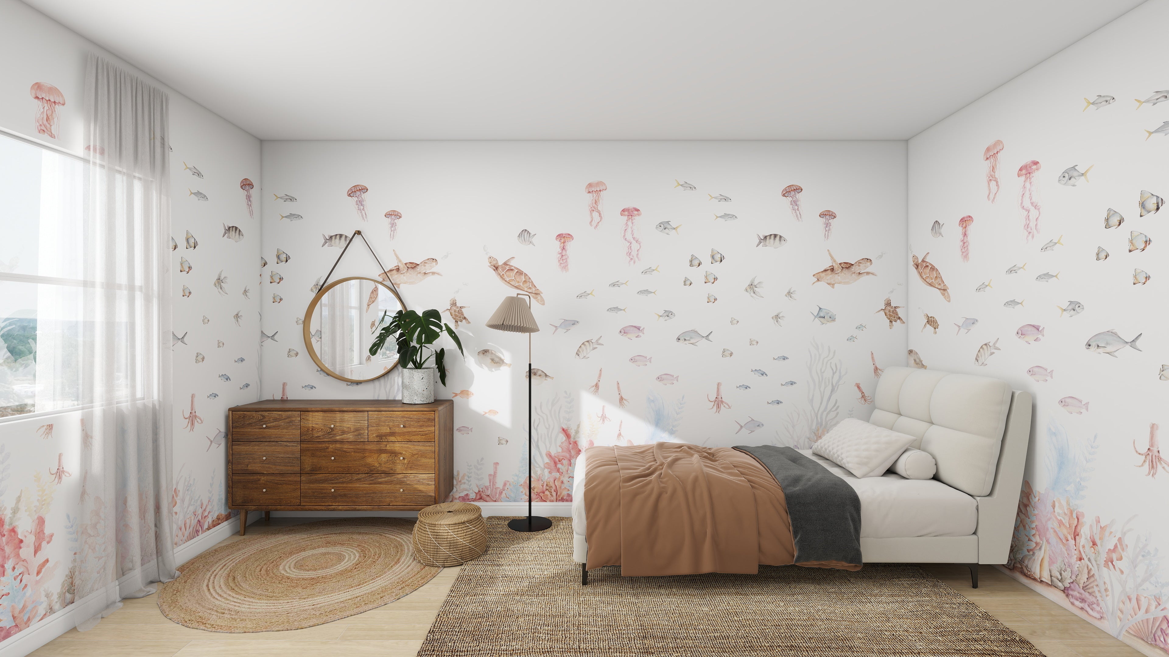 A childrens bedroom styled like an aquatic realm features the Fish Tank Wallpaper Mural by munks and me, showcasing sea creatures like fish, turtles, and jellyfish. The room includes a white bed with a brown blanket, round mirror above a wooden dresser, woven rug, and large window with sheer curtains.