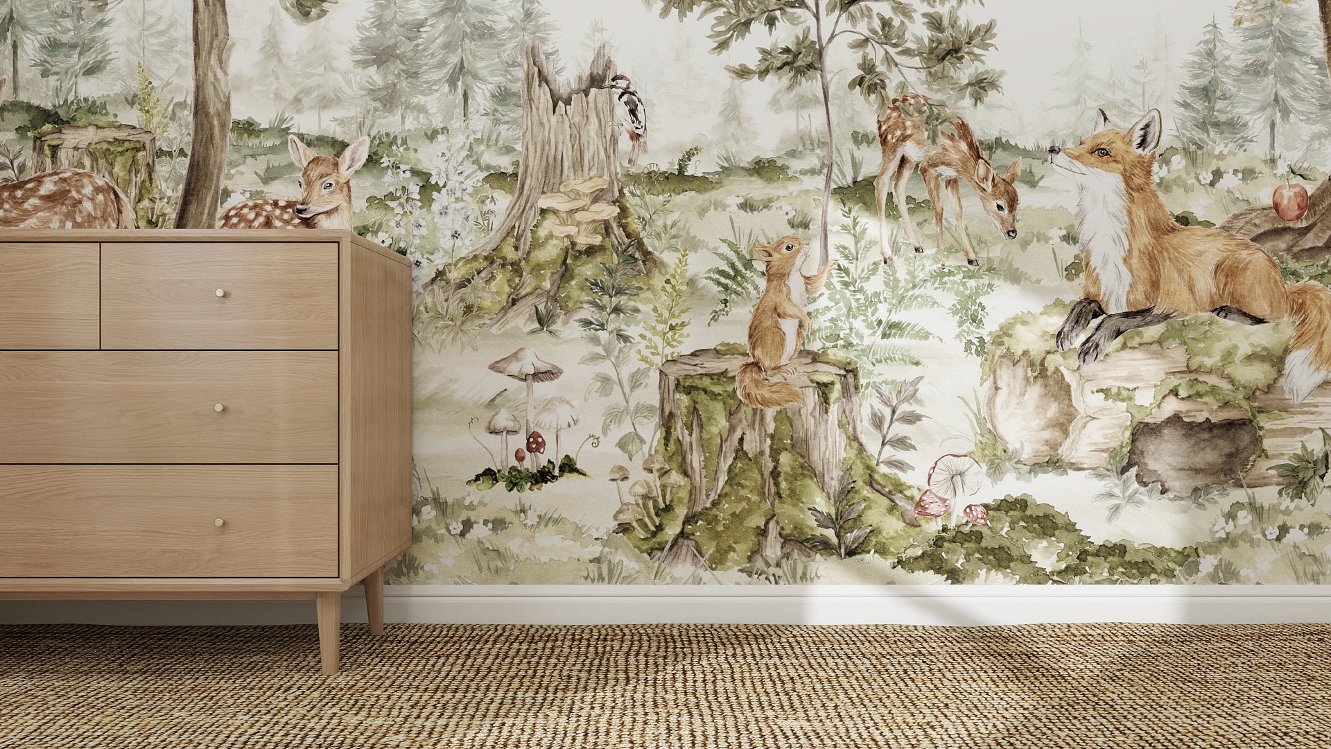 A nursery room features a wooden dresser and the “Into The Forest Wallpaper Mural” with illustrated deer, a fox, squirrels, mushrooms, and trees, creating a whimsical woodland scene.