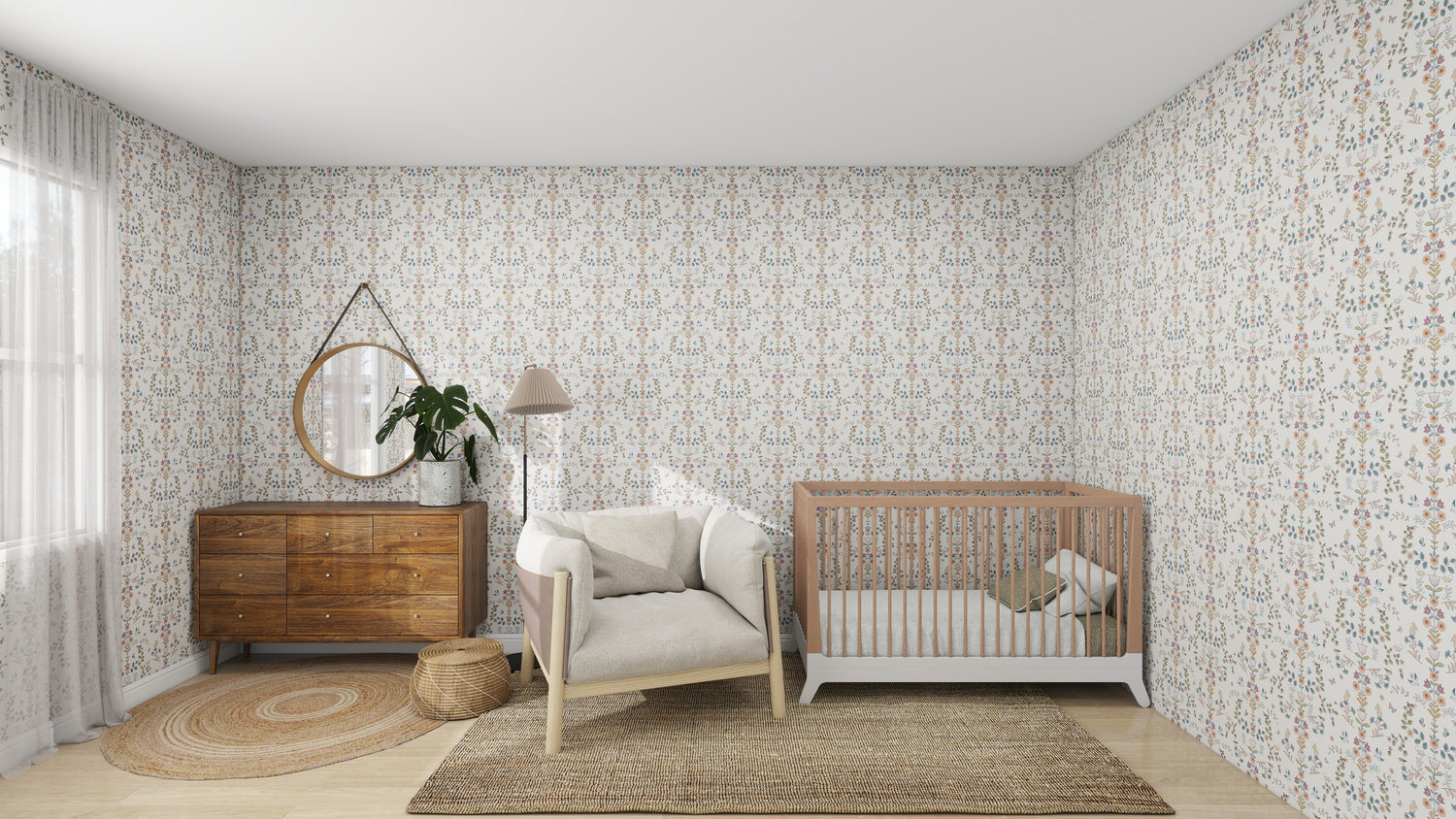 A cozy nursery features the Forest Tales Wallpaper by munks and me, soothingly colored with floral patterns. The room includes a wooden crib, cushioned armchair, matching dresser with round mirror and plant, plus a woven rug and basket on the floor. Soft light filters through sheer curtains for tranquility.