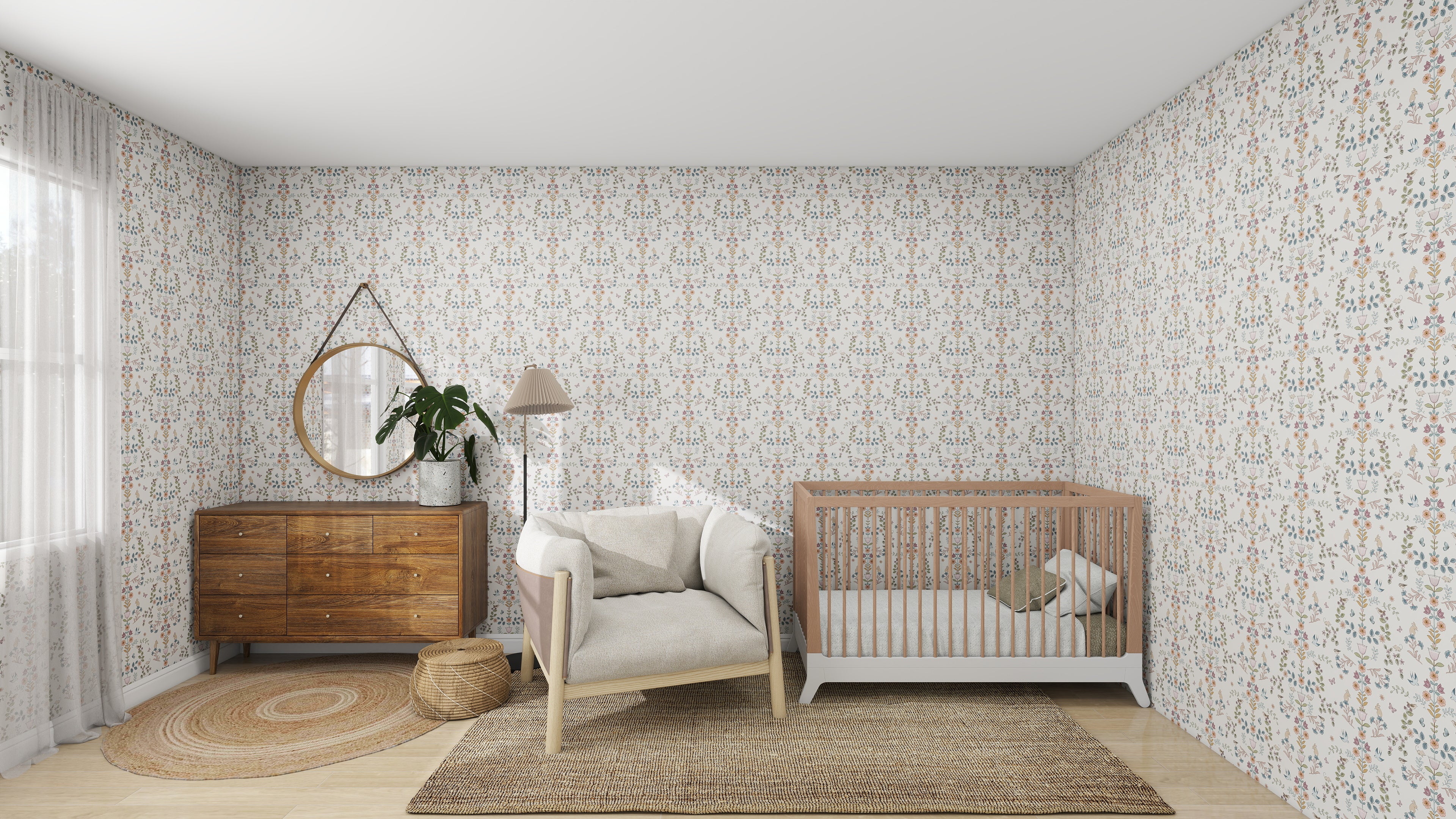 A cozy nursery features the Forest Tales Wallpaper by munks and me, soothingly colored with floral patterns. The room includes a wooden crib, cushioned armchair, matching dresser with round mirror and plant, plus a woven rug and basket on the floor. Soft light filters through sheer curtains for tranquility.