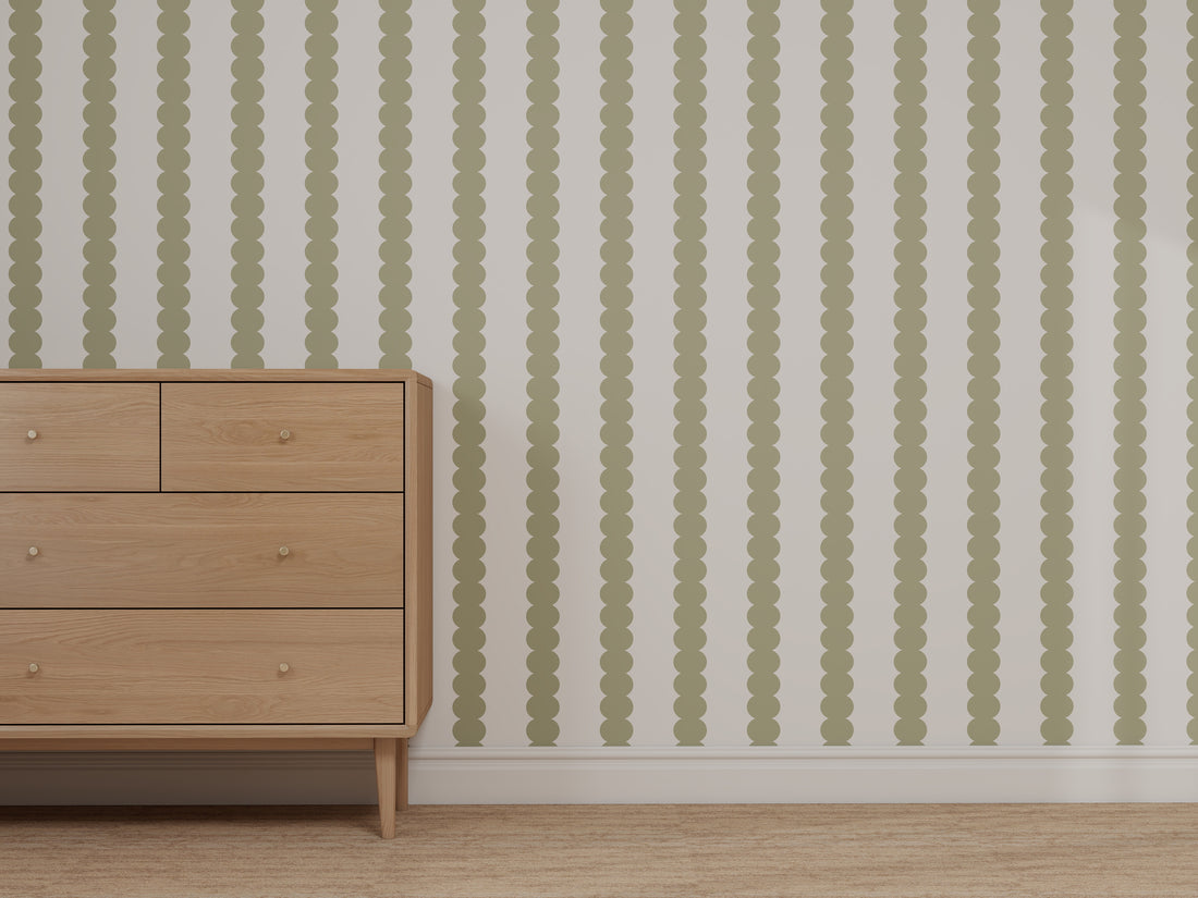 A custom dresser stands on tan carpet against a wall featuring the Custom Green and White Scallop Stripe | Repeat Pattern, creating a minimalist and modern look.