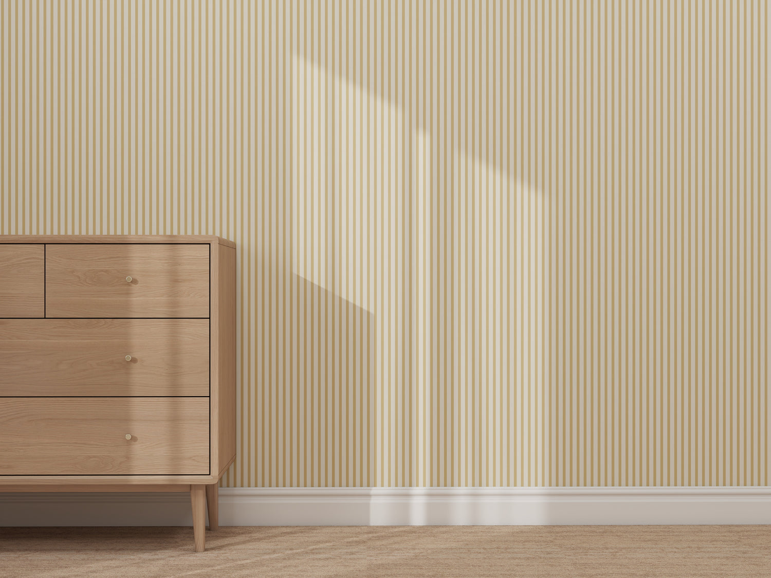 A wooden dresser with drawers stands on a beige carpet beside a wall decorated with Pico Stripe Wallpaper Yellow. Sunlight creates a rectangular shadow on the striped wallpaper, adding to the cozy and inviting atmosphere.