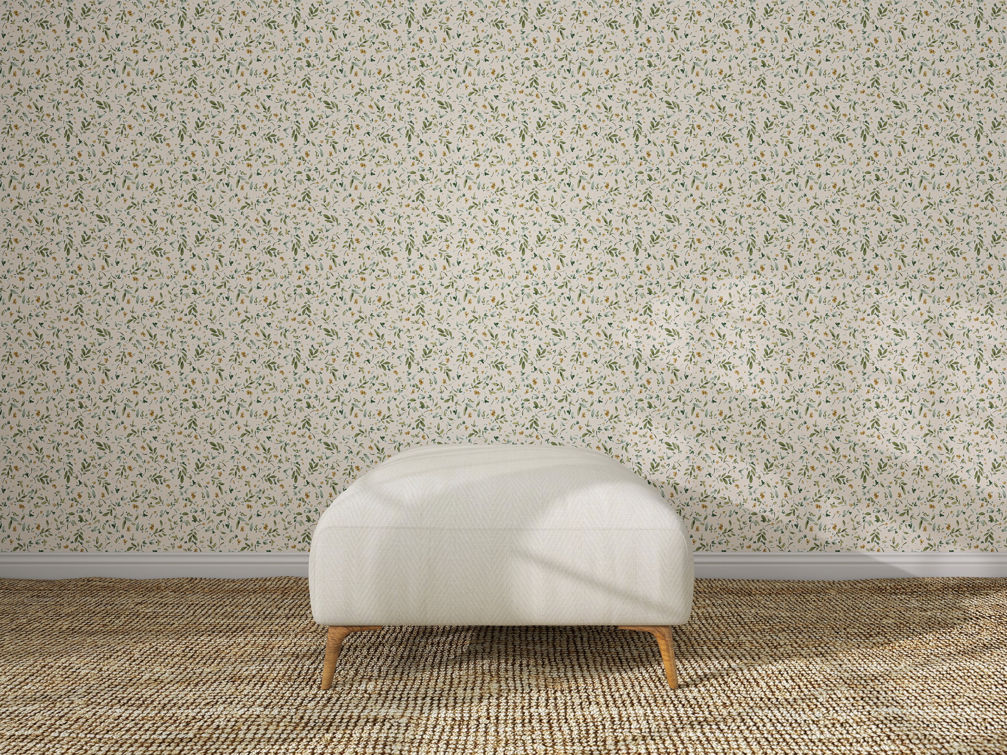 A white upholstered ottoman rests on a textured rug before a wall decorated with Meadow Flutter Leaves Wallpaper, creating a minimal, well-lit kids&