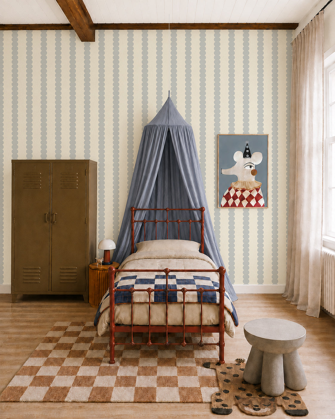 A cozy kids bedroom with a metal bed, patchwork quilt, blue canopy, brown locker, and mouse artwork displayed on Scallop Stripe Wallpaper in Blue. Light filters through beige curtains onto a checkered rug and round table with stools.
