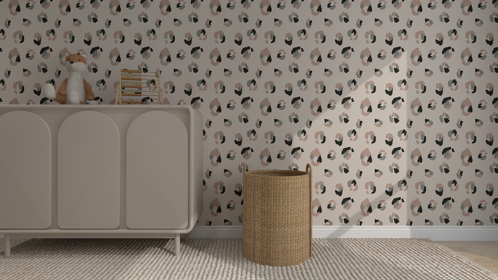 A nursery features a beige dresser topped with a toy fox and books, a wicker basket, and elegant Yara Leopard Print Wallpaper in muted tones. A textured rug completes the warmth of this cozy home decor space.