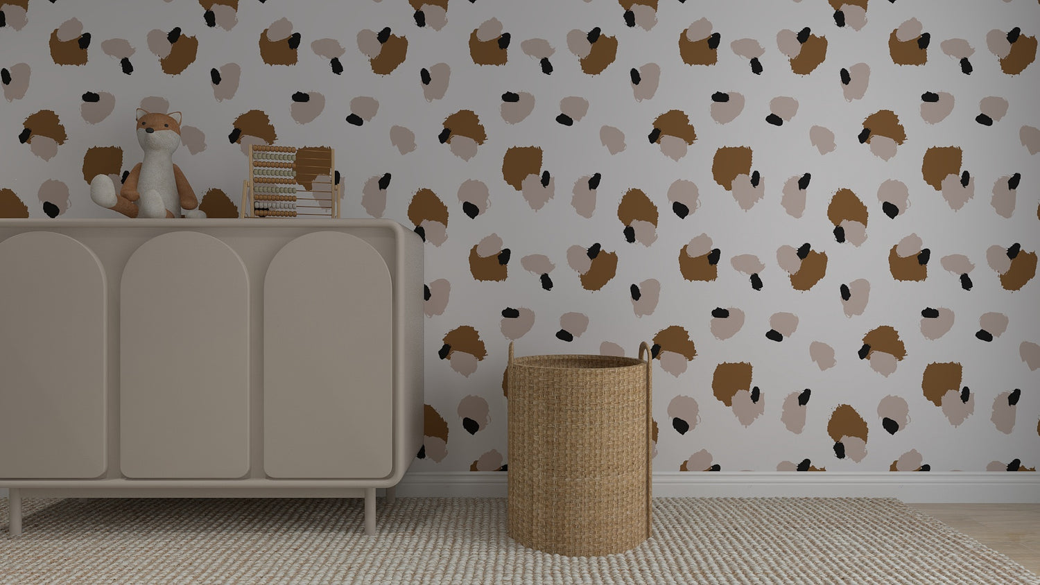 A nursery with a beige dresser holding a plush fox and books, a wicker basket on the right, and whimsical home decor featuring Harry Leopard Print Wallpaper Repeat Pattern in brown, beige, and black. A textured beige rug covers the floor.
