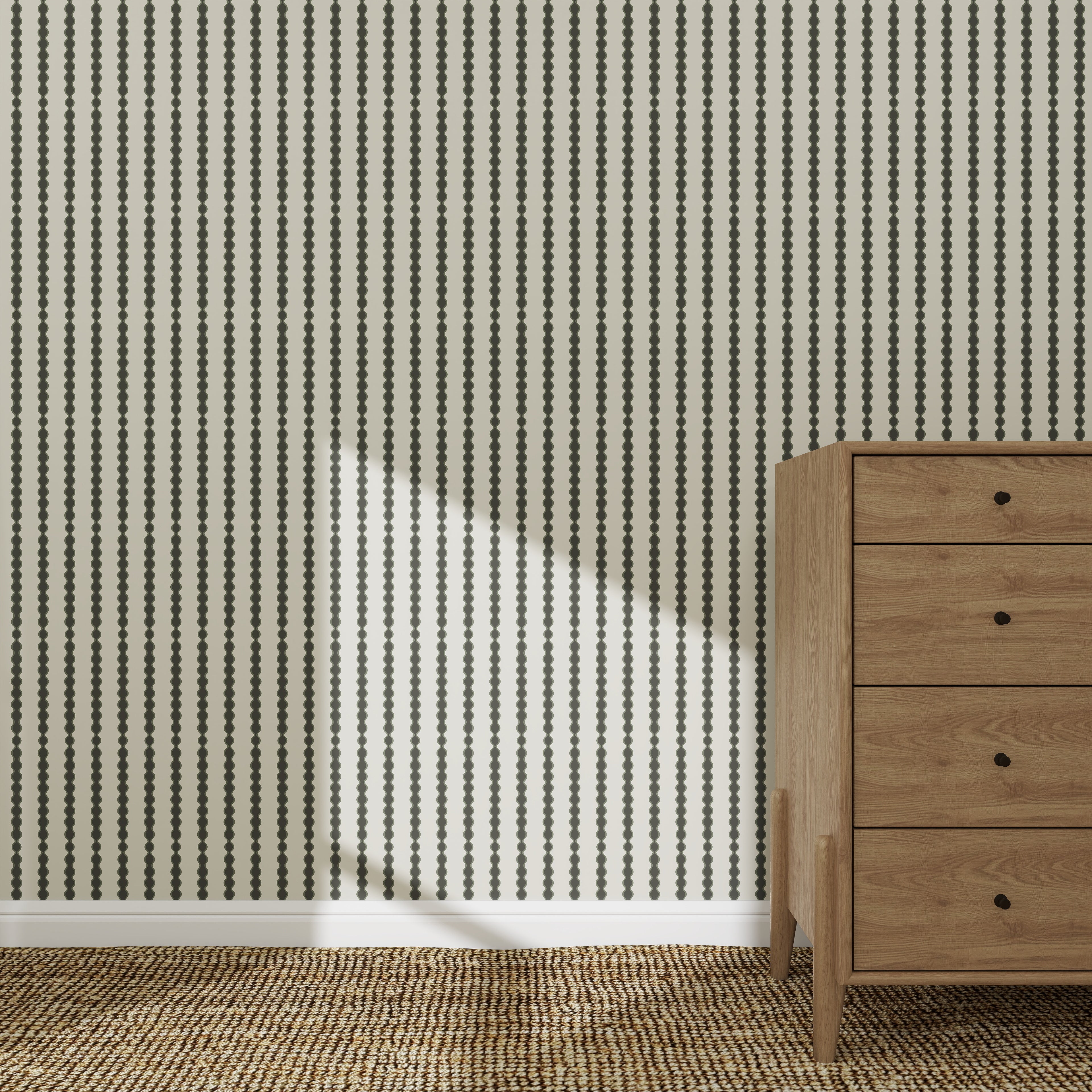 The Little Abacus Stripe Forest wallpaper features bold black dotted stripes behind a wooden four-drawer dresser on a woven rug, with sunlight casting gentle shadows for a serene nursery atmosphere.
