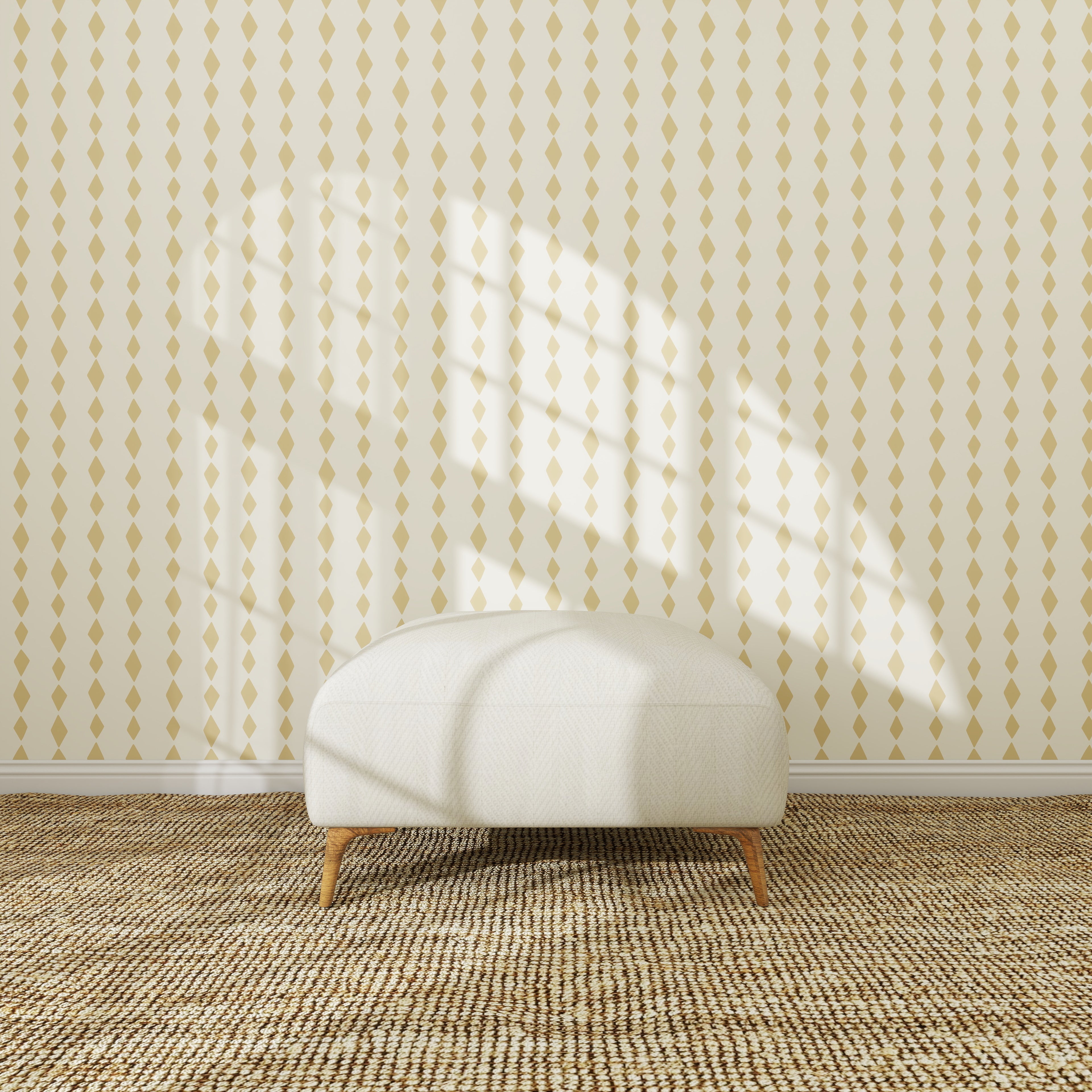 A white, round ottoman sits on a textured woven rug in front of the Jolly Jester Wallpaper Repeat Yellow sample. Sunlight streams through a window, casting geometric shadows that highlight the wallpaper’s quality.