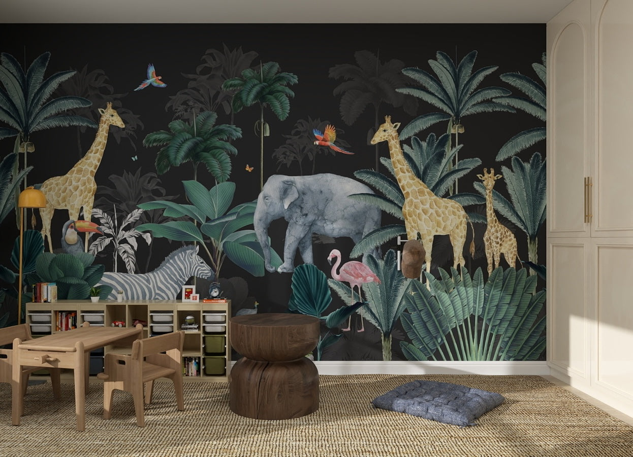 Children’s playroom with a jungle-themed mural of giraffes, elephant, flamingo, zebra, and tropical plants. Wooden furniture and toy shelves sit on a woven rug, enhanced by vibrant Charcoal Jungle Wallpaper.