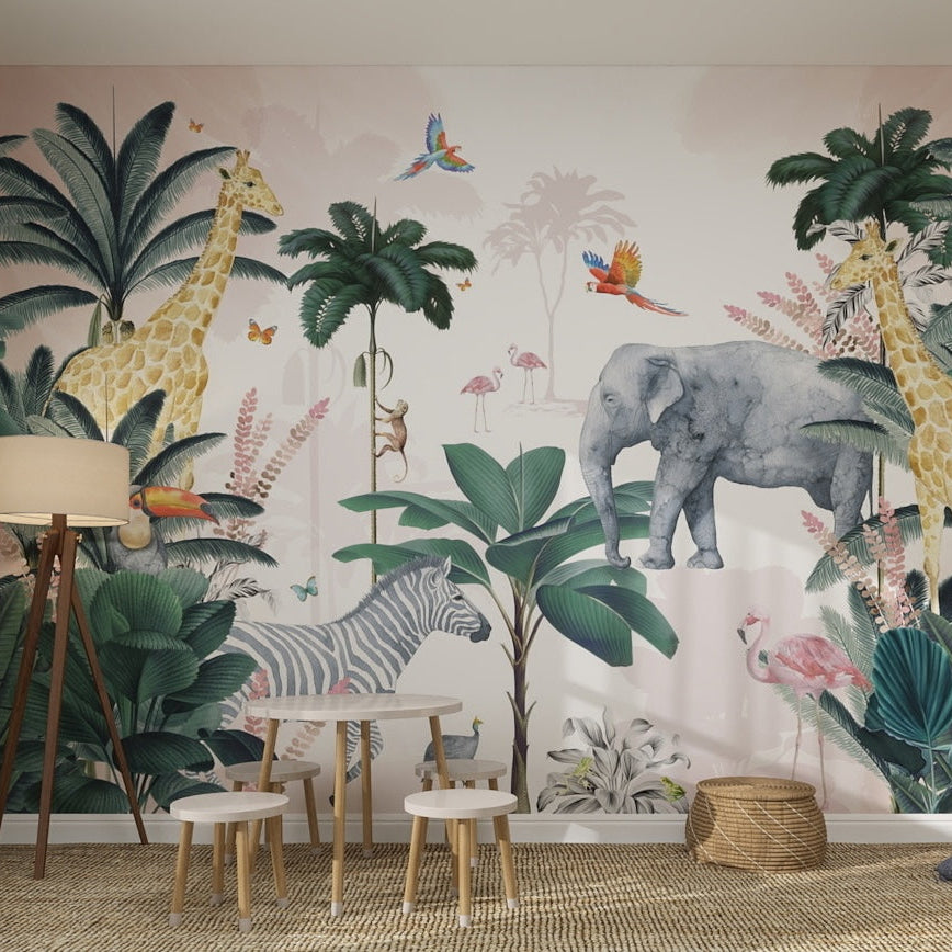 Children’s playroom with a Jungle Mural Sample, Pink—vibrant illustrated jungle animals like giraffes, elephants, zebras, flamingos, and parrots—plus tropical plants, a small table with stools, and soft natural decor.