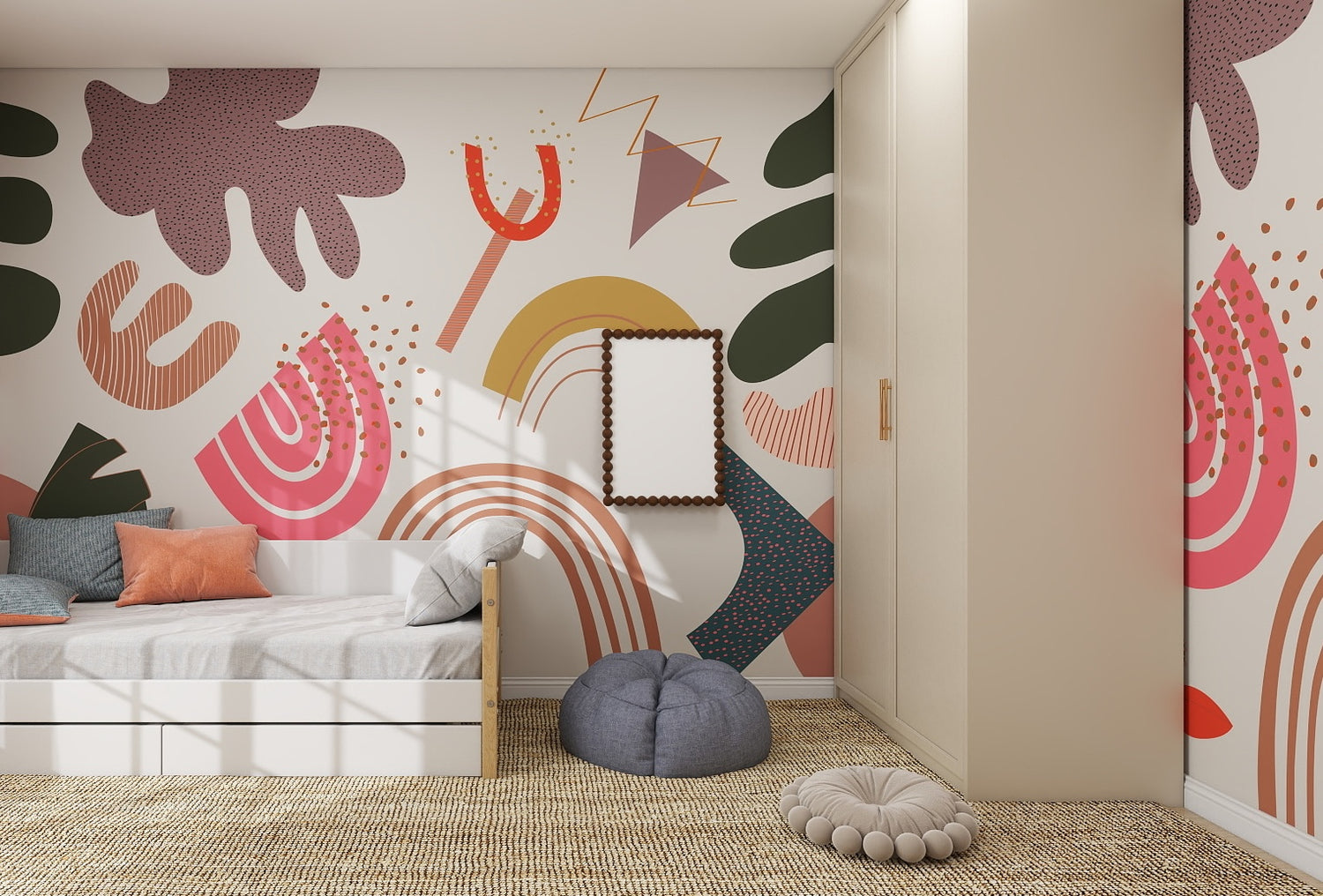 A modern kids’ bedroom with bold wall decor featuring the Little Erin Abstract Wallpaper Mural, a white bed with pastel pillows, gray pouf, beige wardrobe, small framed mirror, and textured woven carpet lit by sunlight from a window.