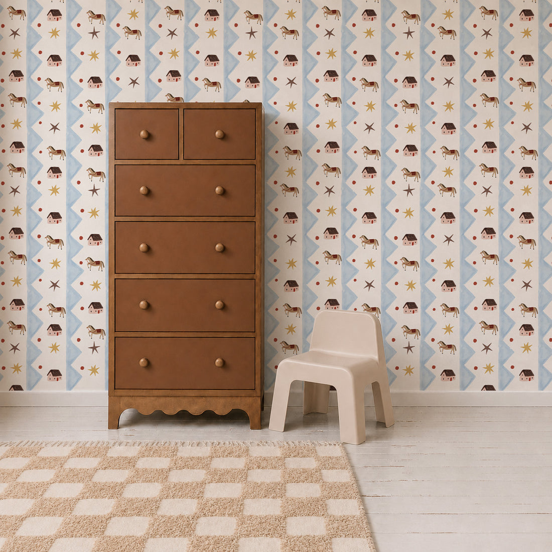 A brown wooden dresser and a small beige plastic chair sit on a checkered rug in a room with white wooden floors and charming Paddock Parade Wallpaper featuring small faces and stars.