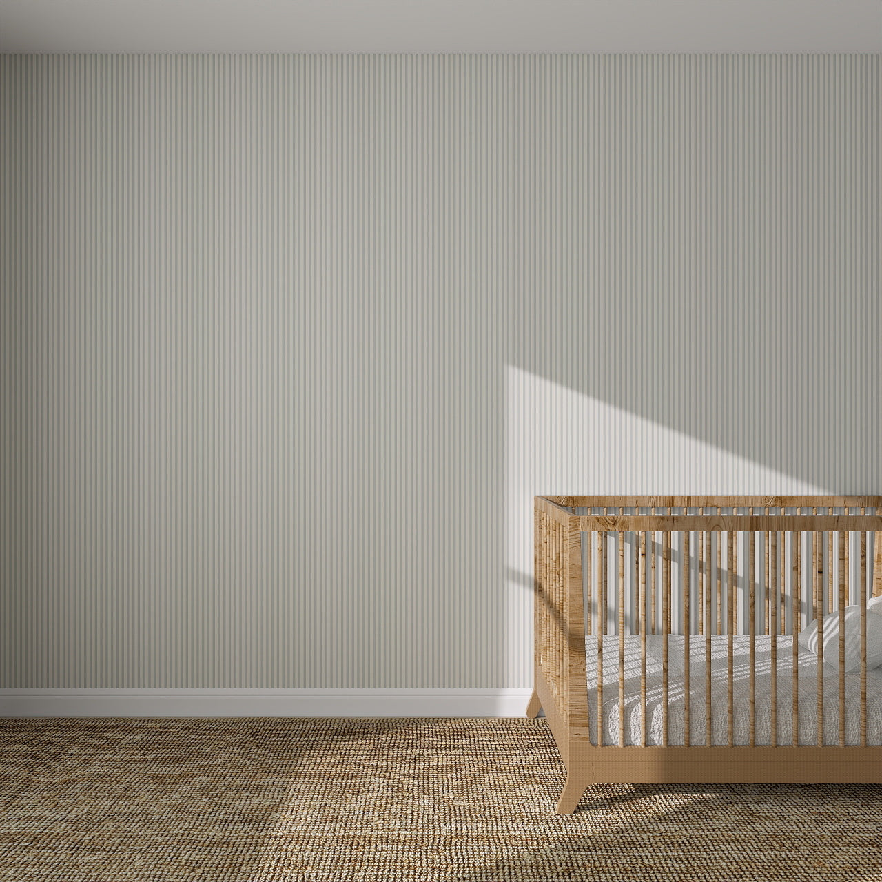 A wooden crib with white bedding sits in the corner of a nursery decorated with Pico Stripe Wallpaper Blue. Sunlight casts a shadow on the wall, while the textured brown carpet covers the floor.