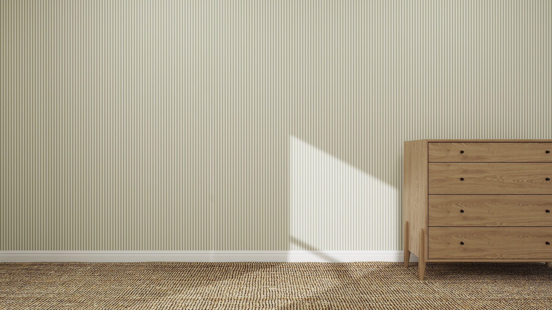 A minimalist room features Pico Stripe Wallpaper Green, a woven brown carpet, and a wooden dresser on the right. Sunlight creates geometric shadows across the wall and floor.