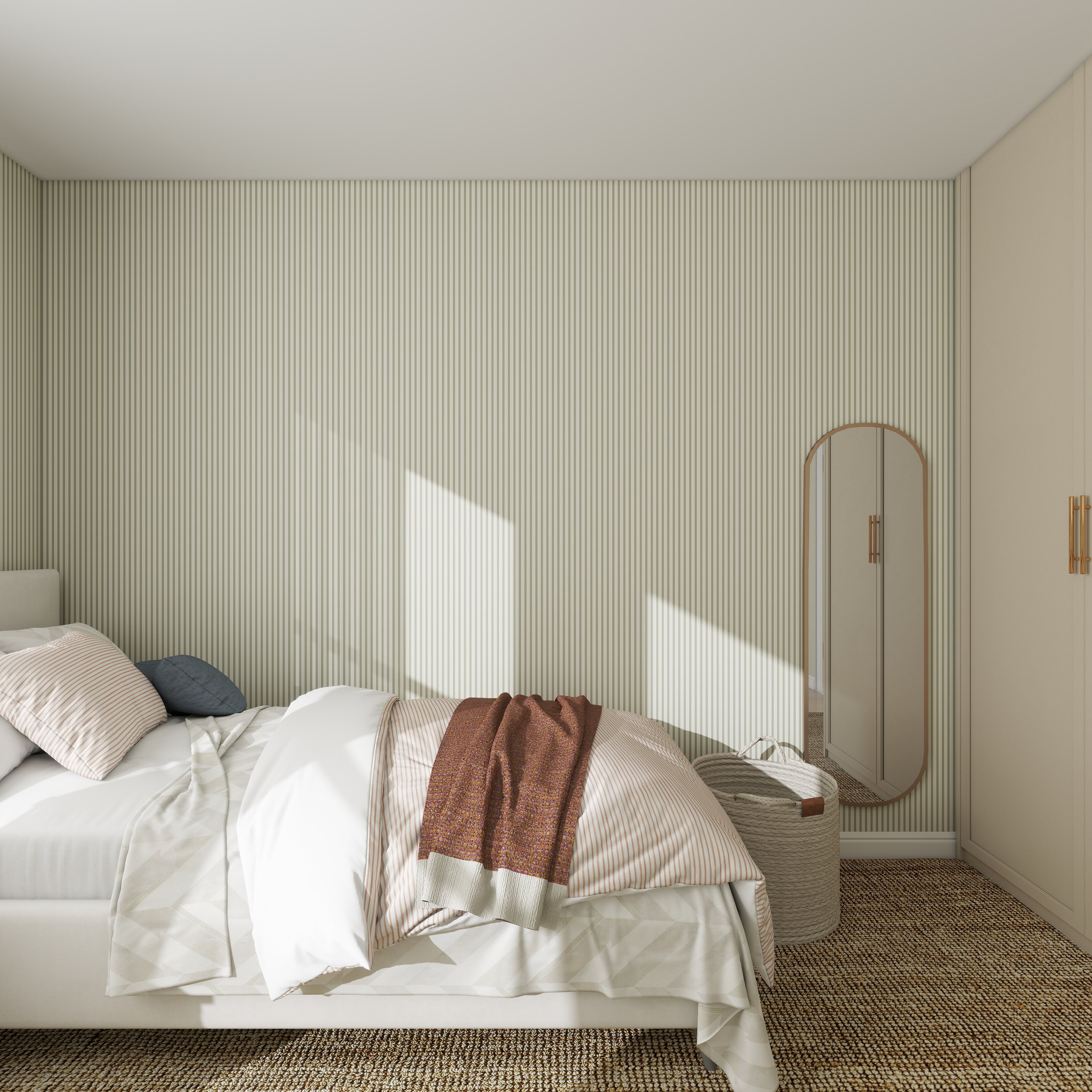 A minimalist bedroom features a neatly made bed with striped bedding and a brown throw, accented by a tall oval mirror and small woven basket against Pico Stripe Wallpaper Green, with sunlight streaming in.