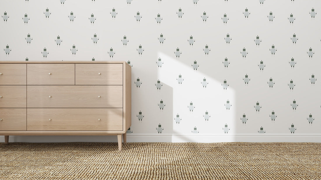 A bright and cheerful kids room features Robot Wallpaper Repeat Pattern on a white wall, behind a light wood dresser with six drawers standing on a woven beige carpet, with sunlight casting playful shadows across the space.