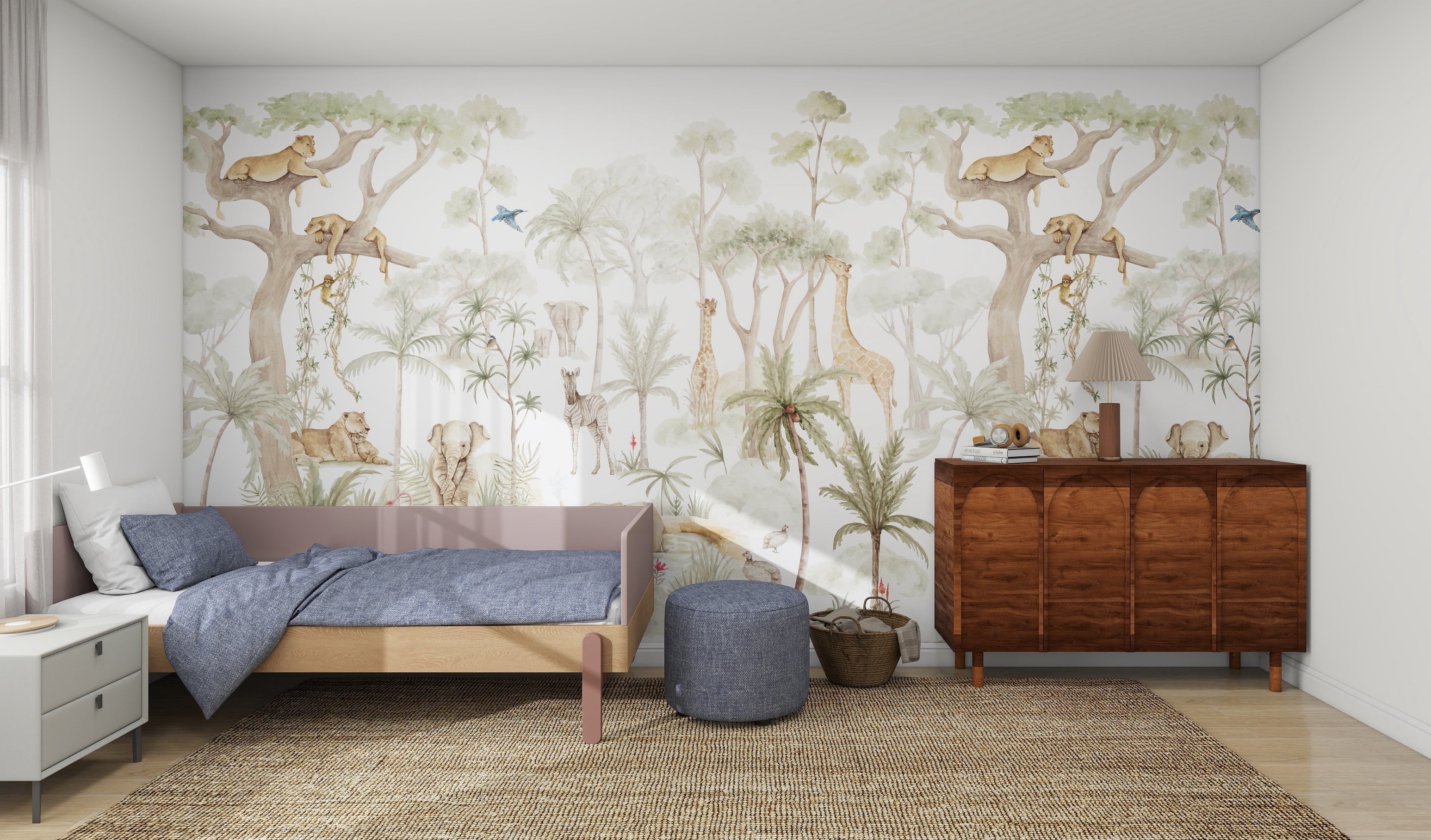 A bedroom features the Safari Savannah Adventure by munks and me, a jungle-themed mural with trees, elephants, giraffes, and birds. It includes a single bed with blue bedding, a woven rug, a small round ottoman, and a wooden dresser topped with a lamp.
