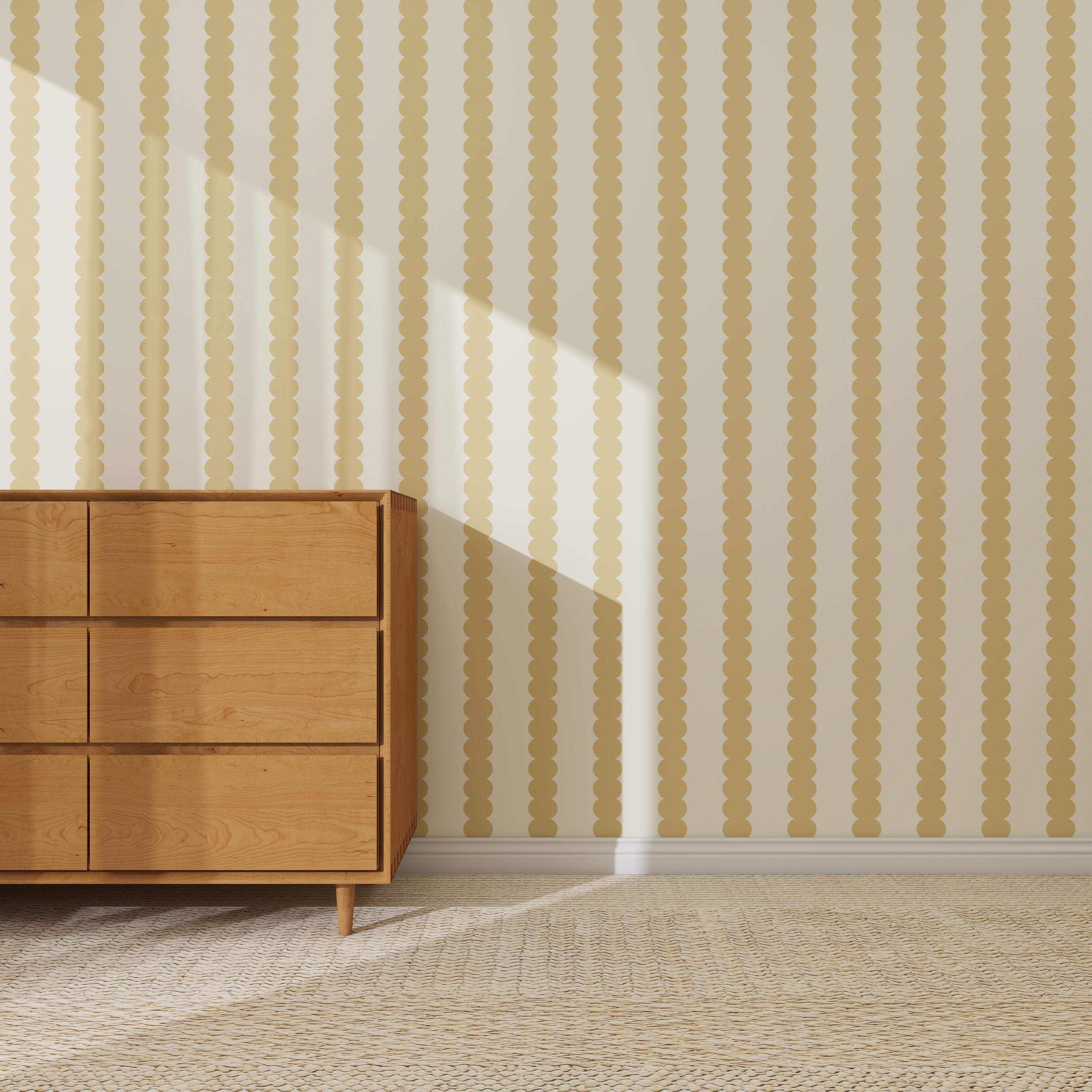 A wooden dresser with six drawers stands on a woven rug against a wall covered in Scallop Stripe Wallpaper Sample, Yellow. Sunlight streams in, casting diagonal shadows that accentuate the wallpaper’s unique yellow and beige stripes.