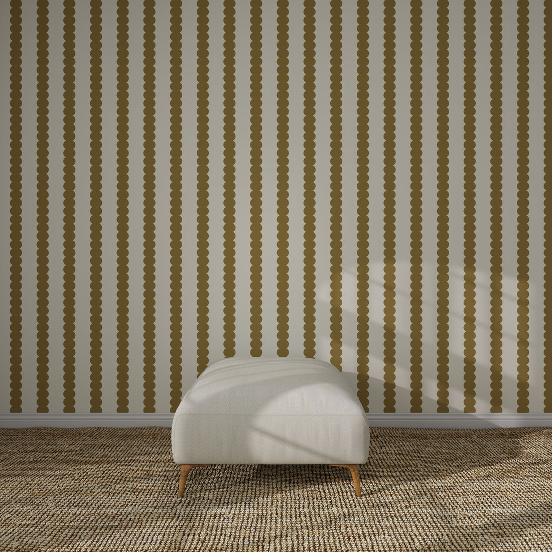 A minimalist room features a white cushioned ottoman on a brown patterned carpet, set against a wall adorned with Scallop Stripe Wallpaper Sample, Moss. Sunlight casts shadows across the ottoman and the striped wallpaper.