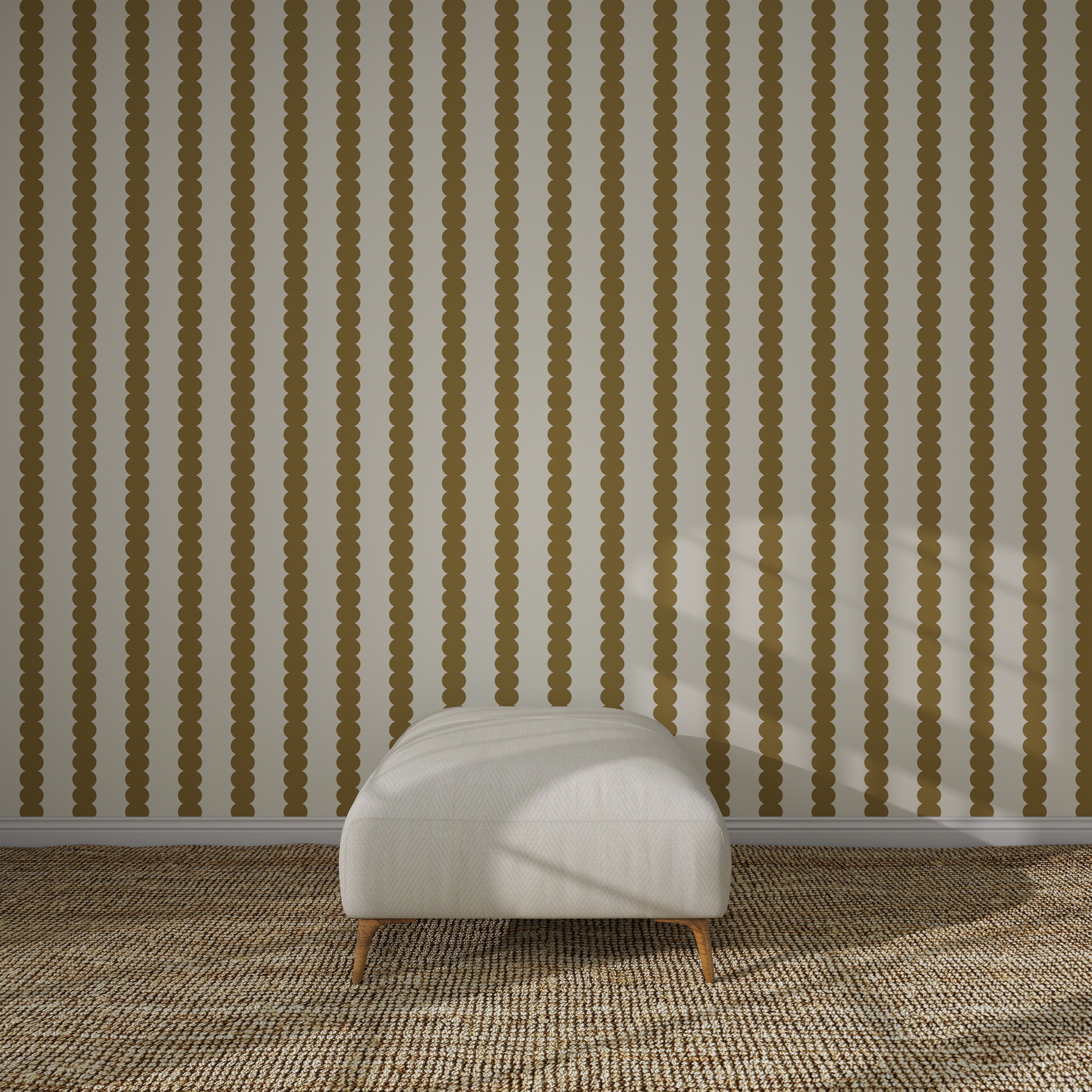 A minimalist room features a white cushioned ottoman on a brown patterned carpet, set against a wall adorned with Scallop Stripe Wallpaper Sample, Moss. Sunlight casts shadows across the ottoman and the striped wallpaper.