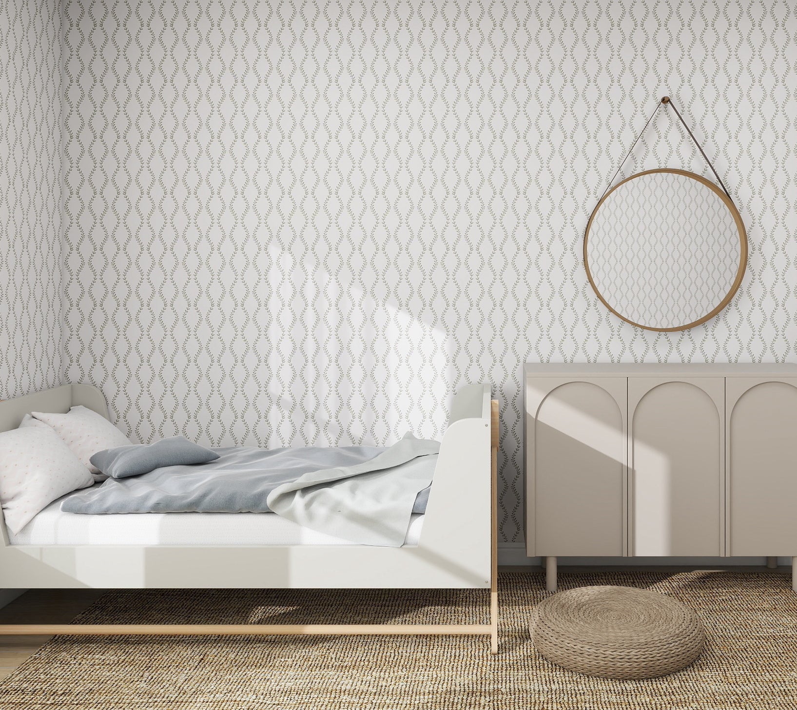 A minimalist bedroom features a single bed with white and gray bedding, a light wooden frame, and a beige woven rug. A beige cabinet supports a round mirror, while the Vintage Vines Wallpaper Repeat Pattern by munks and me adds subtle geometric charm.