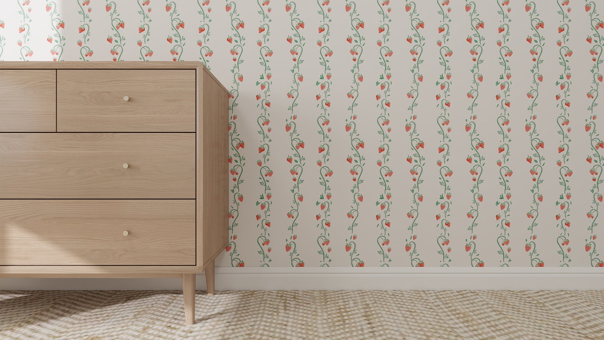 A light wood dresser with round knobs stands on a beige carpet. Behind it, the Strawberry Stripes Wallpaper Repeat Pattern—cream with vertical green vines and small pink flowers—adds a whimsical touch, perfect for a child’s room.