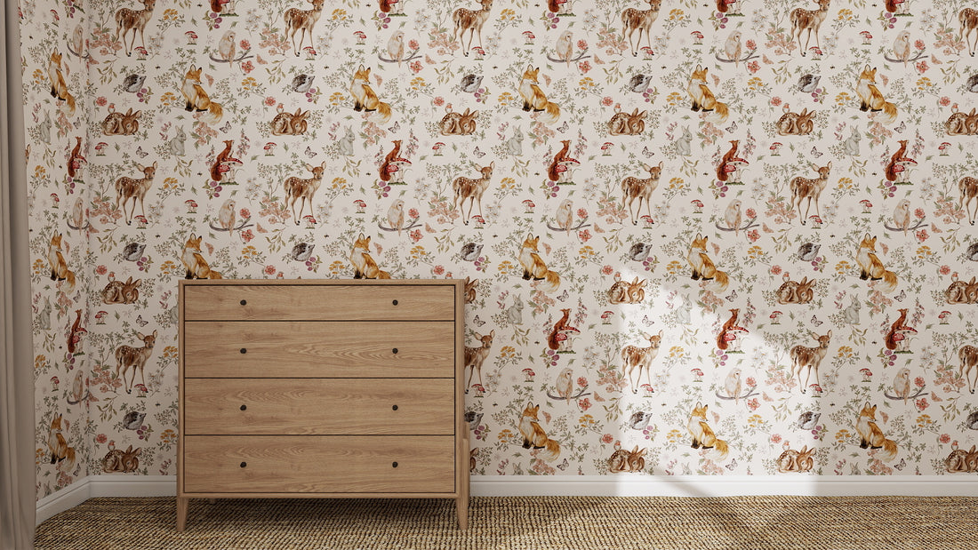A wooden dresser stands against a wall decorated with Whimsical Woodland Wallpaper, which showcases colorful illustrations of woodland animals and plants. The floor is covered in neutral-toned carpet.