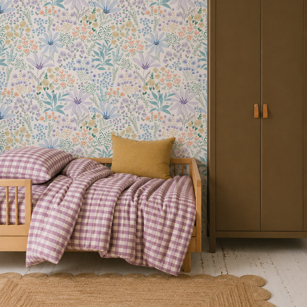 A cozy bedroom with a wood bed, purple checkered bedding, yellow pillow, and the Wildflower Waltz Wallpaper that brings a touch of nature decor. The room features a brown wardrobe and a woven rug on white wooden floors.