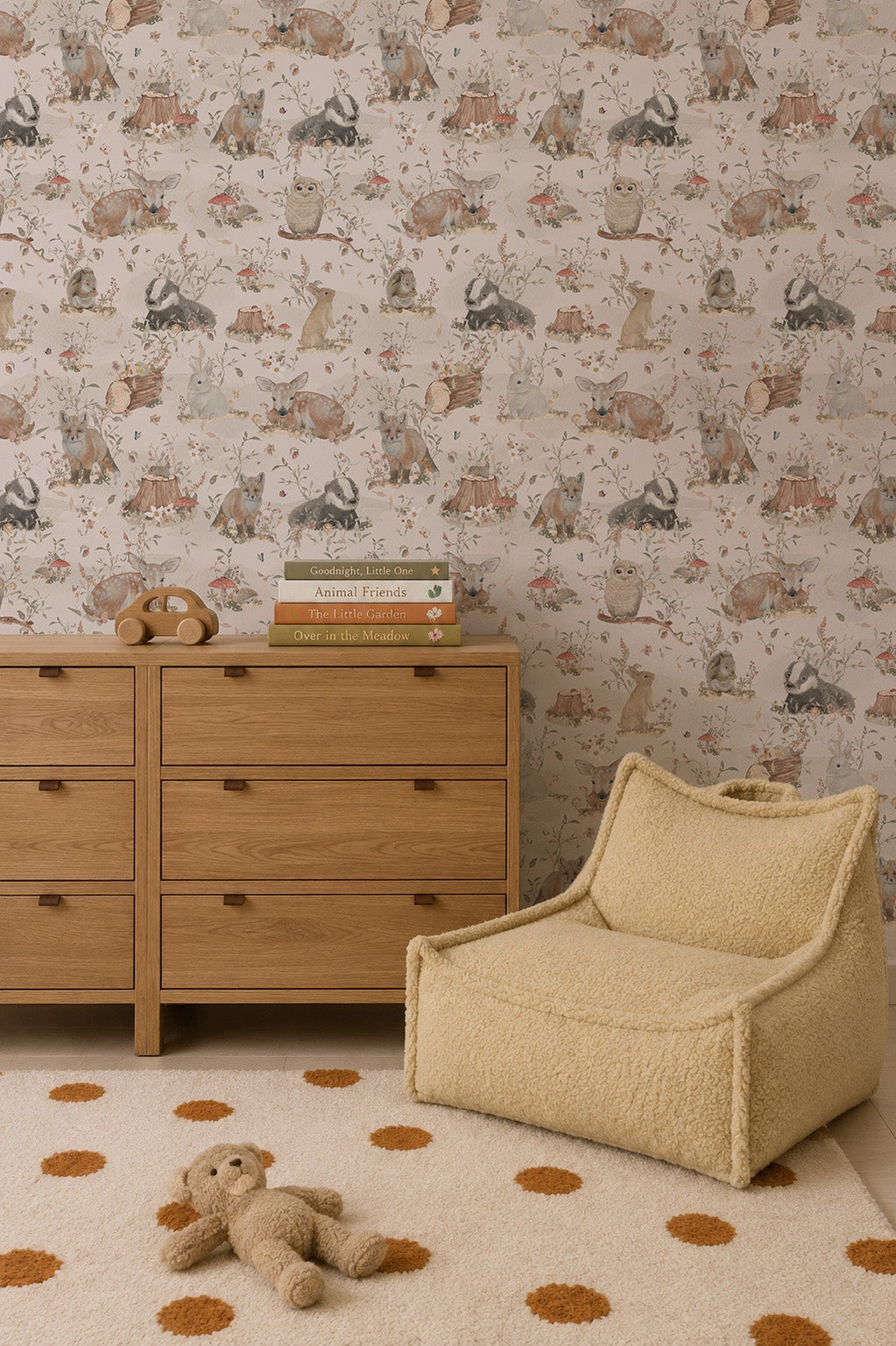 A cozy nursery includes a wooden dresser with four drawers, children&