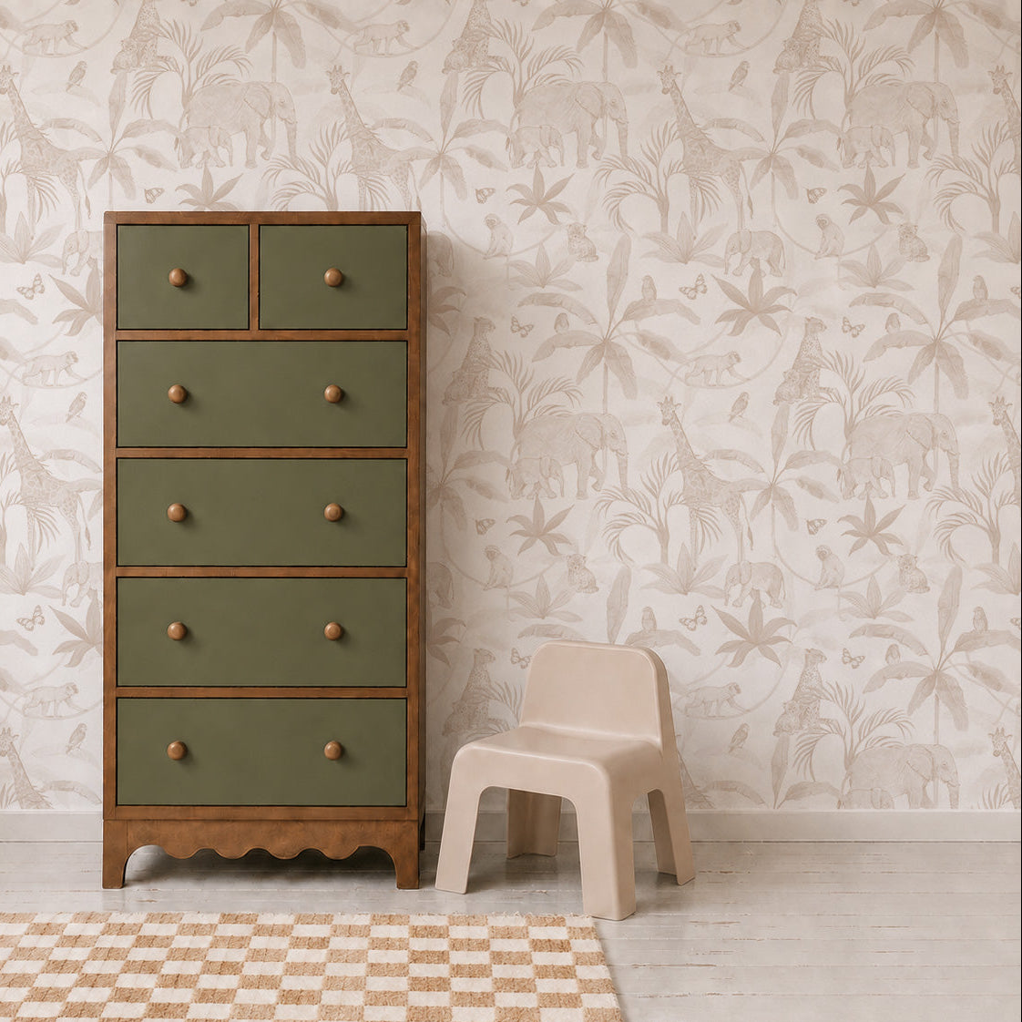 A green and wooden dresser stands next to a small beige plastic chair in a room decorated with African Safari Wallpaper, Neutral, featuring playful safari animals and a beige checkered rug on a light wooden floor.