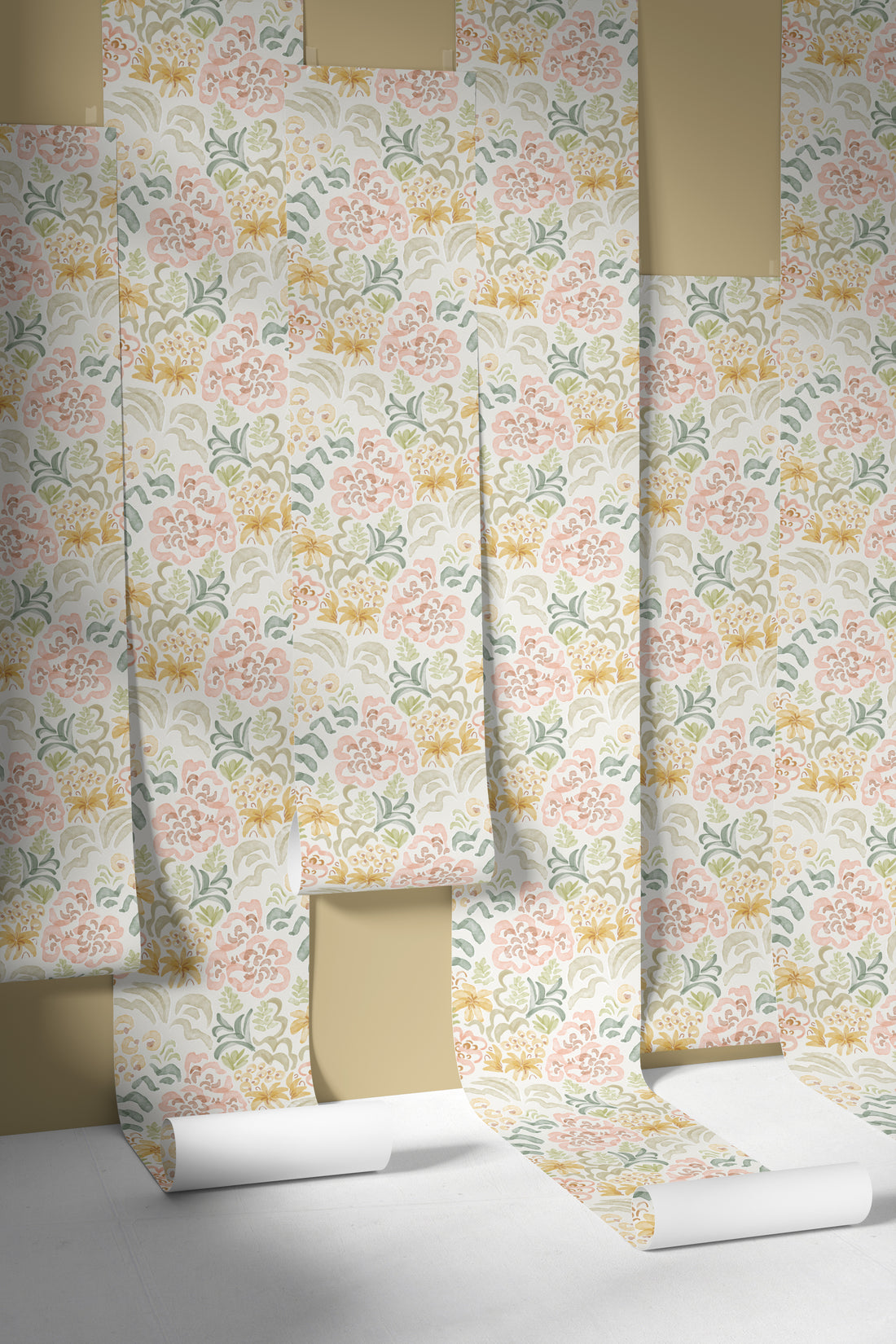 Several rolls of Floret Dreamscape Wallpaper Repeat Pattern in pastel pink, yellow, and green are partially unrolled and layered against a beige background, highlighting their unique design and textured appearance.