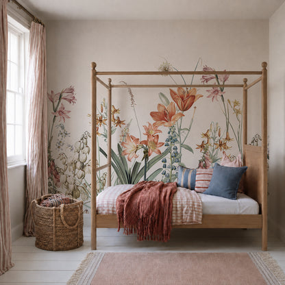 A cozy bedroom features a wooden canopy bed dressed in pastel bedding, topped with a rust-colored throw and matching pillows. The wall showcases the Quinns Flower Field Mural, bringing the vibrant look of a blooming garden indoors. Next to the window with pink curtains, a woven basket adds an extra touch of warmth.