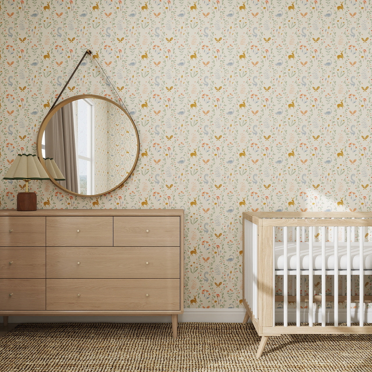 A nursery features Coles Berry Patch Wallpaper Repeat Pattern with butterflies, a wooden dresser, lamp, round mirror, and a wooden crib with white rails atop a woven rug. Sunlight filters through beige-curtained windows.