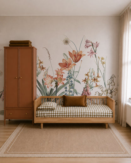 A cozy room with a wooden bed, checkered bedding, brown pillows, a rust-colored wardrobe, and the large Quinns Flower Field Mural adorning the wall behind. Beige curtains and a rug complete the warm, inviting decor.