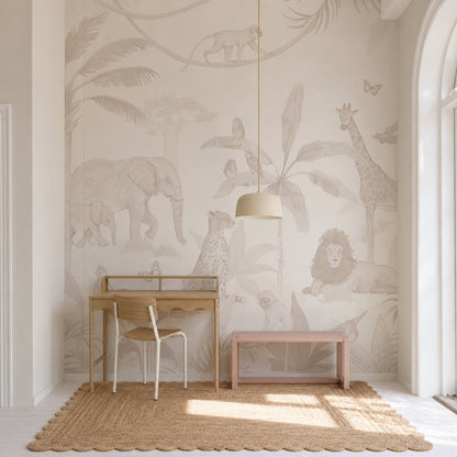 A neutral-toned children’s room with a wooden desk, chair, bench, and a rug features the enchanting African Safari Mural, Neutral—a wall mural depicting safari animals such as an elephant, giraffe, lion, cheetah, and birds among leafy plants.