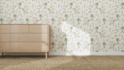 A light wood dresser stands against a wall with Tropical Tiger Wallpaper Repeat Pattern featuring tigers and palm trees; a woven rug lies on the floor as sunlight creates playful shadows across the cheerful, tropical room.