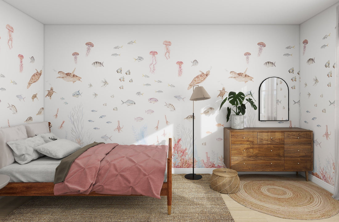 A cozy bedroom adorned with the Fish Tank Wallpaper Mural by munks and me, featuring fish and jellyfish. It includes a wooden bed with pink bedding, a wooden dresser with a mirror, a floor lamp, and a round woven rug on the wooden floor—ideal for online imagery enthusiasts.
