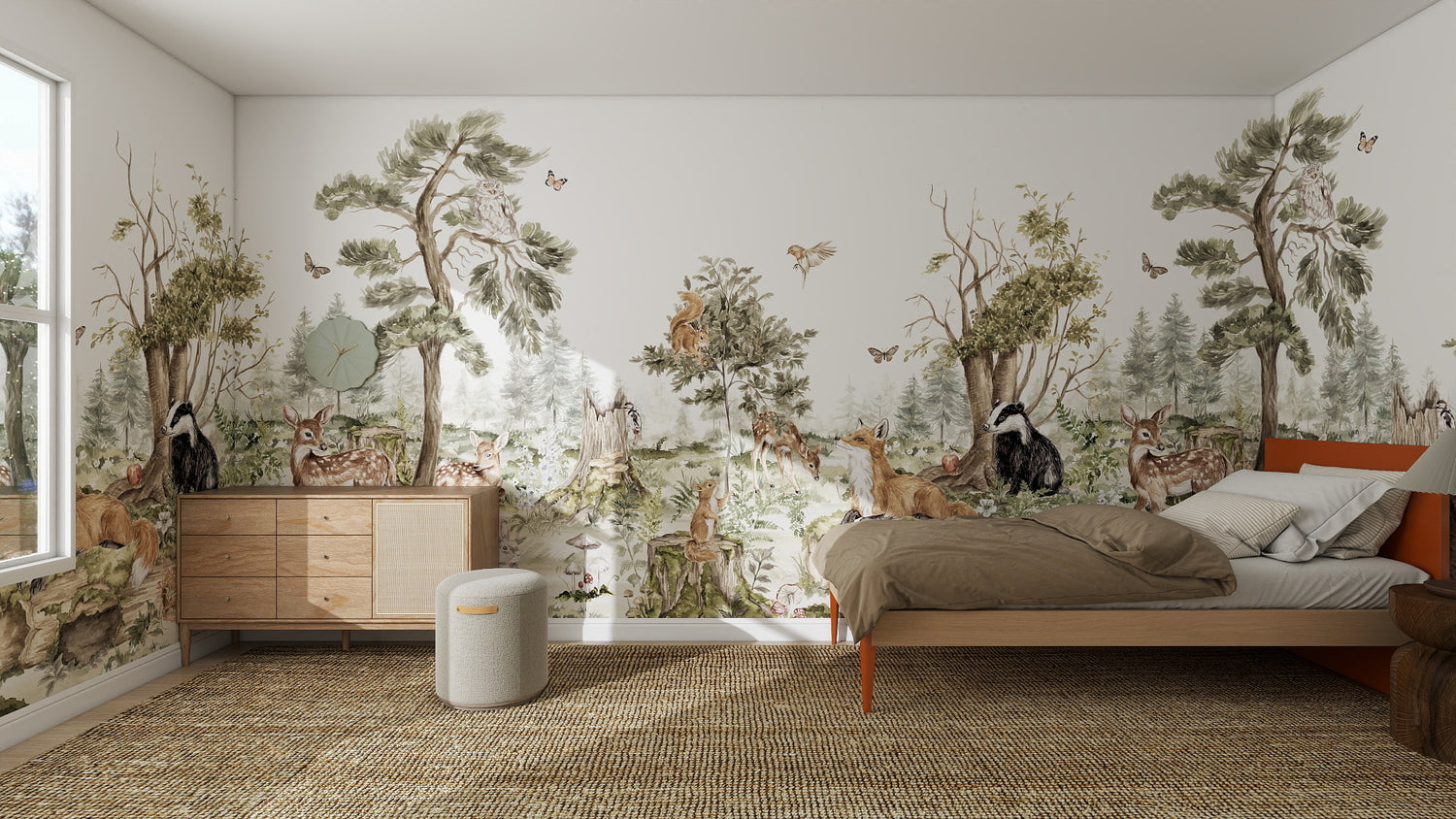 A cozy bedroom features the Into The Forest Wallpaper Mural Sample in stunning quality, showcasing trees, deer, foxes, owls, and butterflies. Sunlight streams onto the bed, nightstand, dresser, and woven rug through a large window.