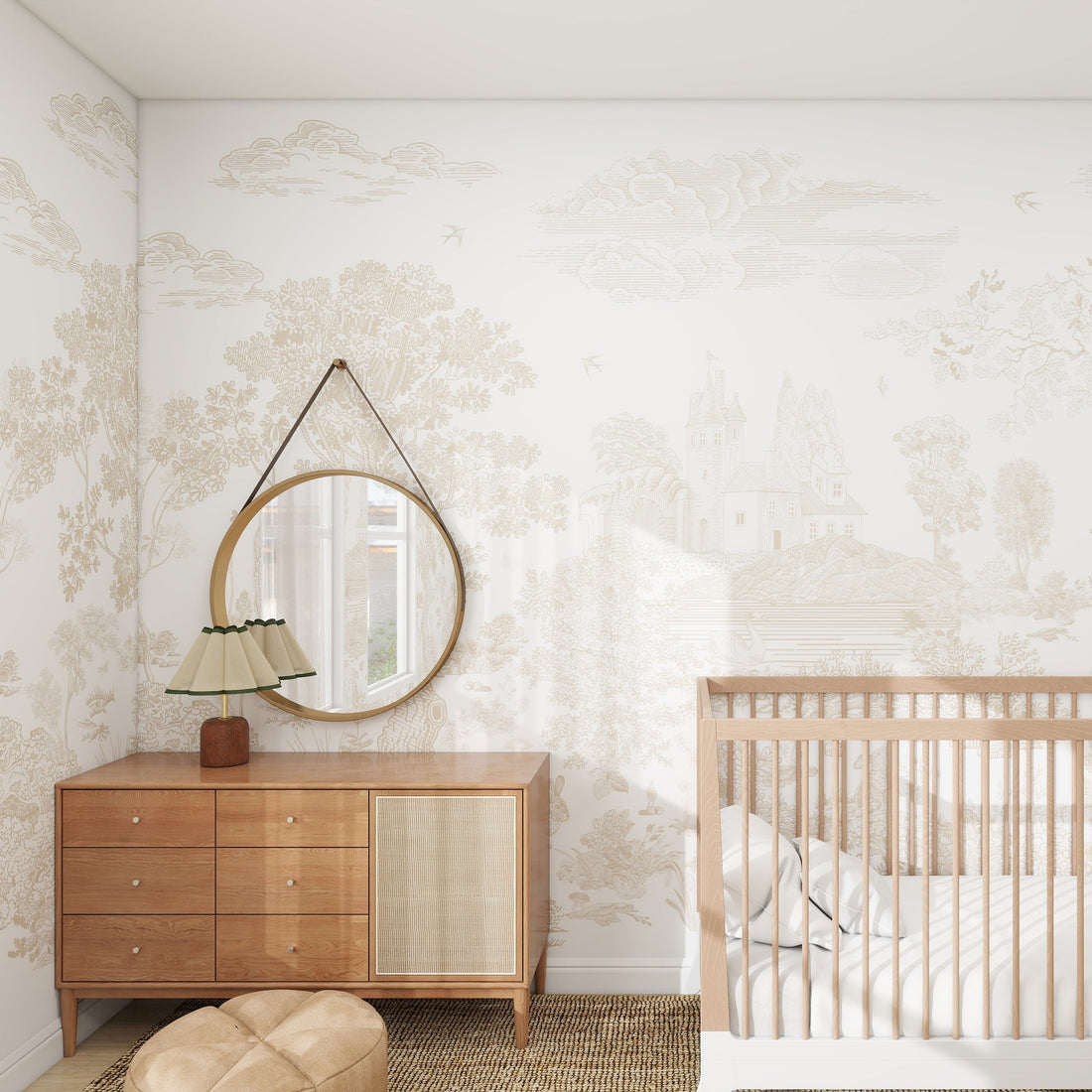 A nursery room features a wooden crib and a dresser with a round mirror. A small lamp adorns the dresser. Forest Hideaway Wallpaper Neutral adds charm, while a soft ottoman sits on the woven rug. Sunlight filters through sheer curtains, creating an enchanting kids play space.