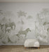 A minimalist room with a textured rug, white ottoman, and the Custom Jungle Mural Wallpaper V1_1 | Sample featuring softly colored safari animals and palm trees—ideal for adding a playful yet elegant touch to your space.