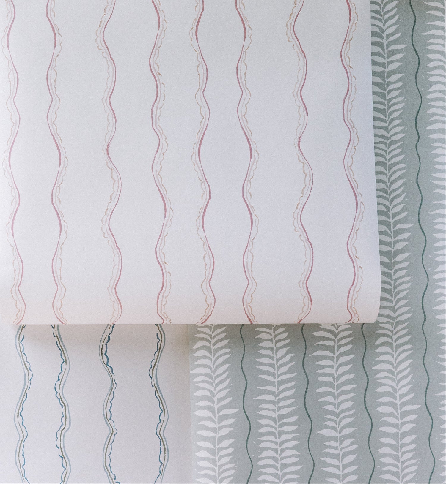 The Ribbon Stripe Wallpaper, Blue features simple blue wavy stripes on white, offering elegant and playful decor that&