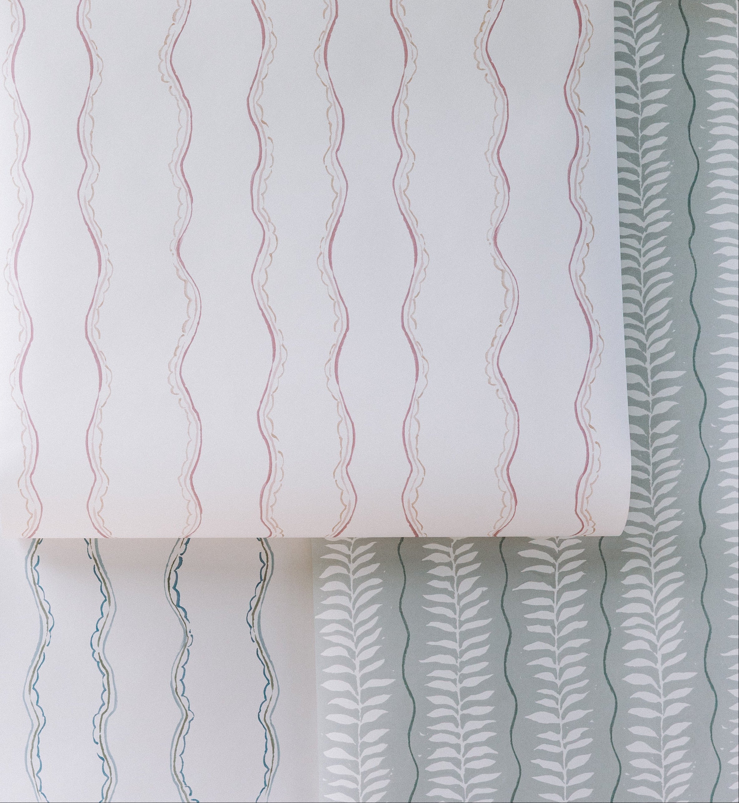 The Ribbon Stripe Wallpaper, Blue features simple blue wavy stripes on white, offering elegant and playful decor that&