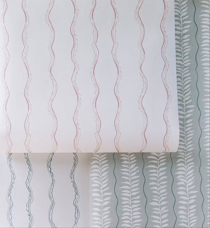 The Ribbon Stripe Wallpaper, Blue features simple blue wavy stripes on white, offering elegant and playful decor that&