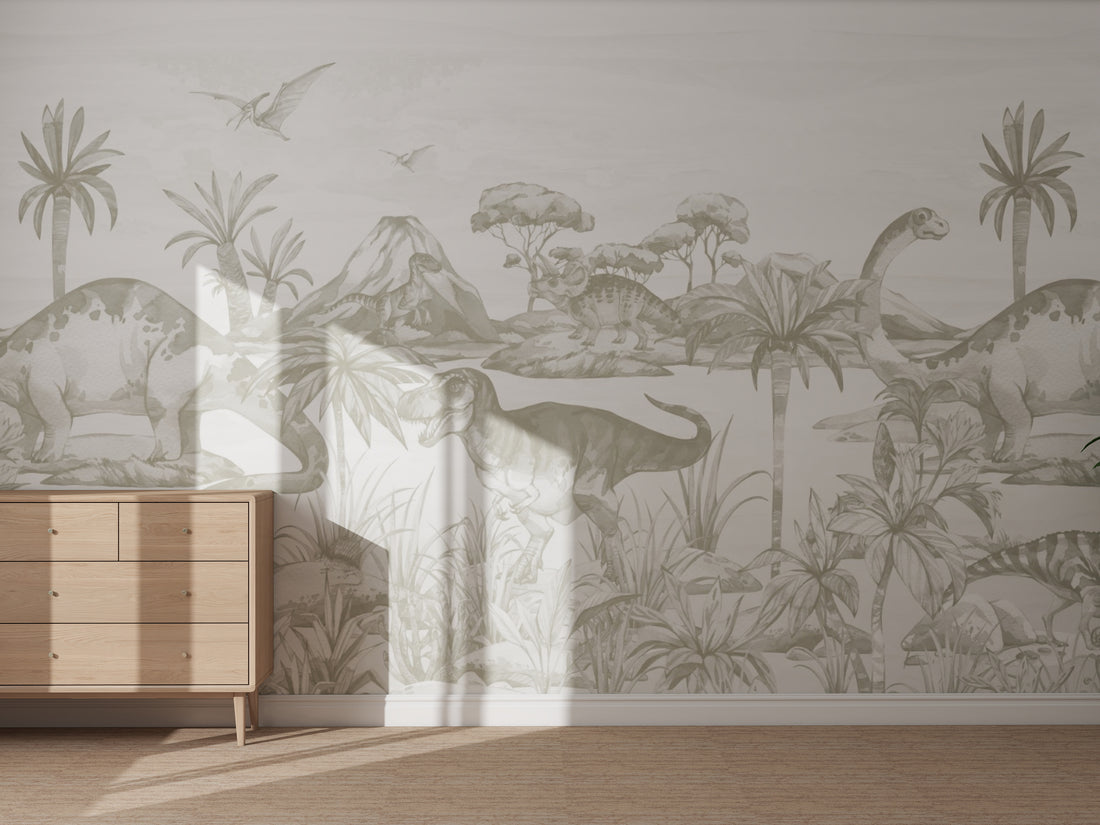 A sunlit room with a wooden dresser features the &quot;Custom Dinosaur World Mural | Custom colour Green,&quot; depicting dinosaurs, volcanoes, and palm trees in muted tones for a prehistoric-inspired look.